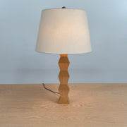 The Donghia Zig Zag Lamp Pickled Oak by Donghia features a white fabric shade and geometric wooden base, displayed on a light wood surface against a plain background.