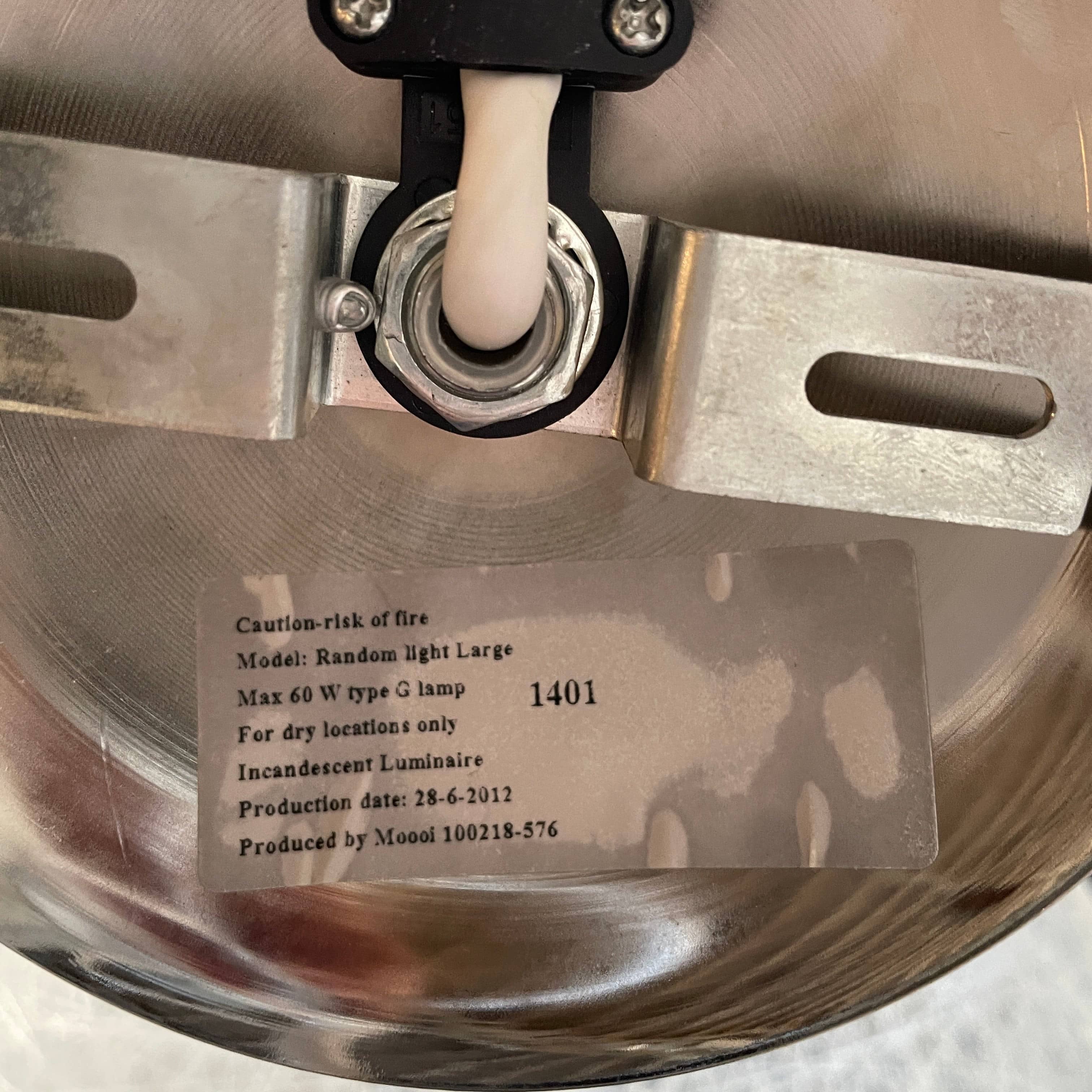 A Moooi Random Pendant suspension light with a white ball, reminiscent of the Moooi Random design, hanging from a light fixture.