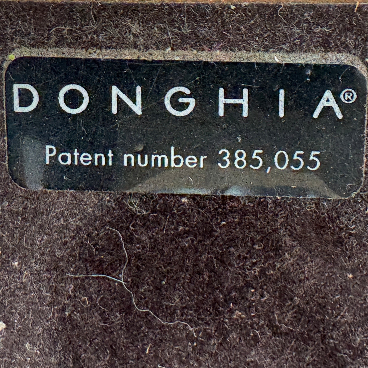 The Donghia Zig Zag Lamp Pickled Oak by Donghia features a white fabric shade and geometric wooden base, displayed on a light wood surface against a plain background.