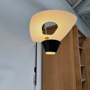 The Sammode G25 Wall lamp by Modern Resale features a black and white design, mounted above a light wood cabinet in a room with exposed ceiling beams.