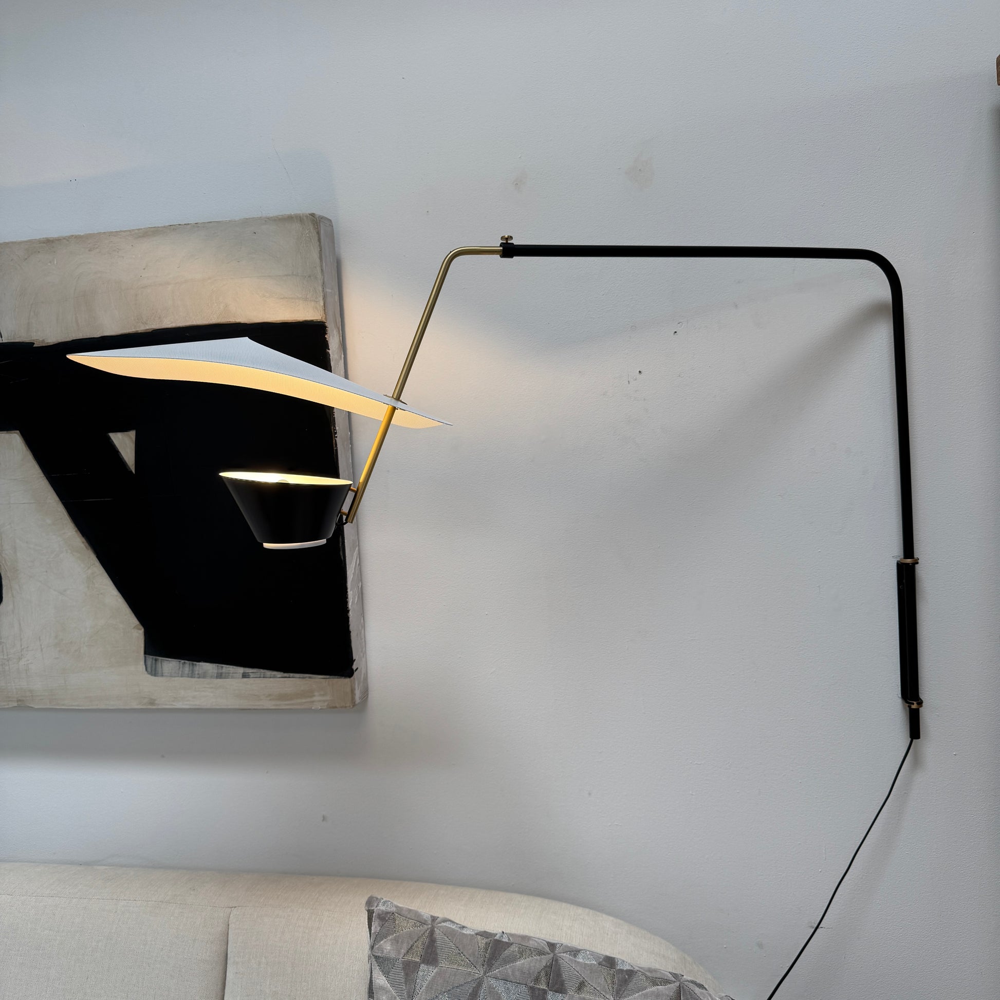 The Sammode G25 Wall lamp by Modern Resale features a black and white design, mounted above a light wood cabinet in a room with exposed ceiling beams.