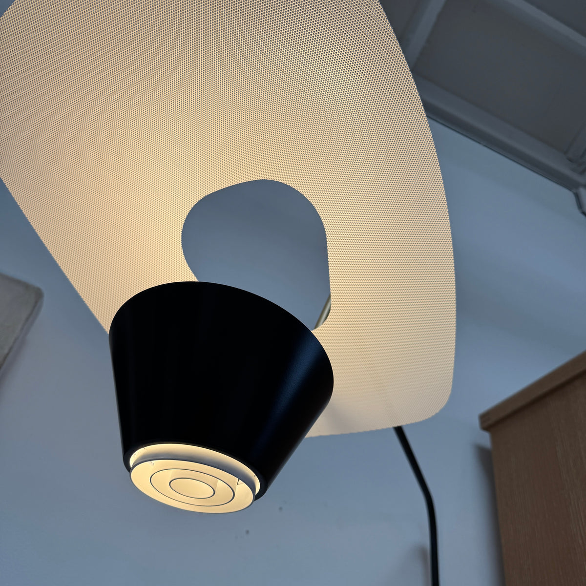 The Sammode G25 Wall lamp by Modern Resale features a black and white design, mounted above a light wood cabinet in a room with exposed ceiling beams.