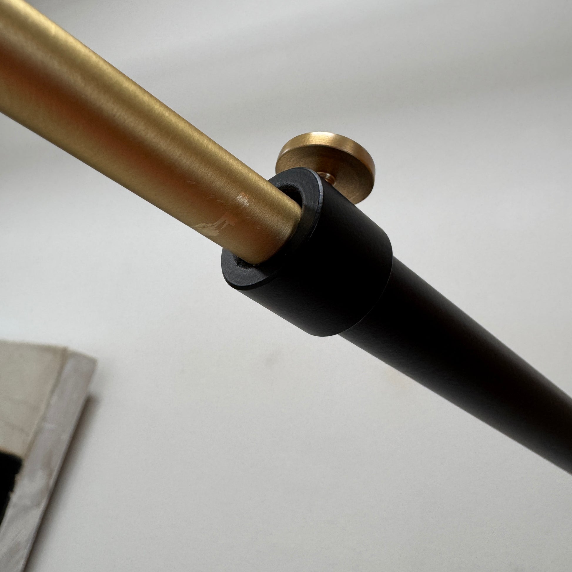 The Sammode G25 Wall lamp by Modern Resale features a black and white design, mounted above a light wood cabinet in a room with exposed ceiling beams.