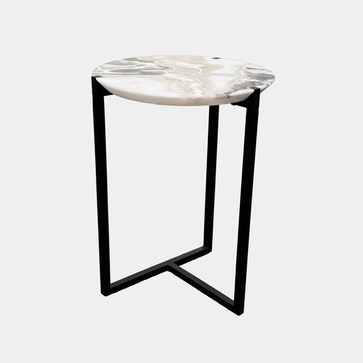 The Baxter Icaro Polar White Marble Accent Table - Small by Baxter showcases a sleek black metal base and a smooth Polar White marble top, photographed against a plain white background.