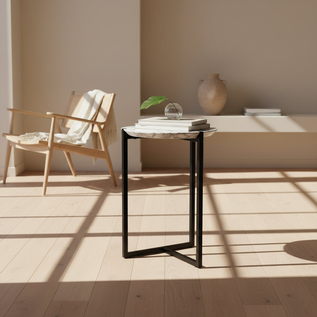 The Baxter Icaro Polar White Marble Accent Table - Small by Baxter showcases a sleek black metal base and a smooth Polar White marble top, photographed against a plain white background.