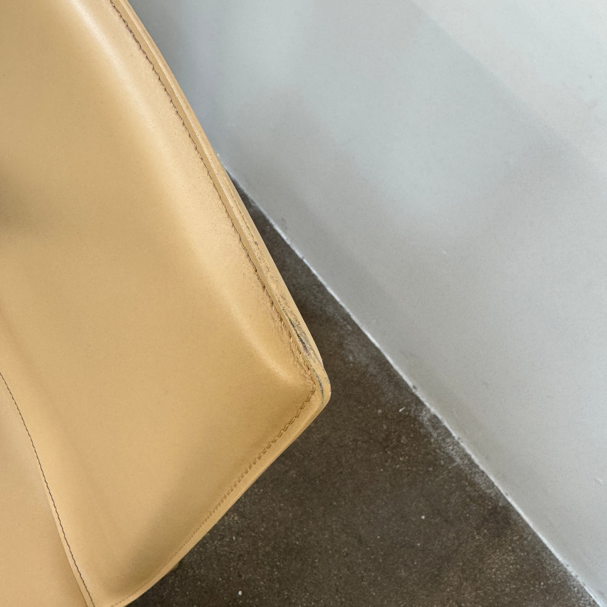 Eight light-tan Frag Bottega leather dining chairs arranged in two rows.