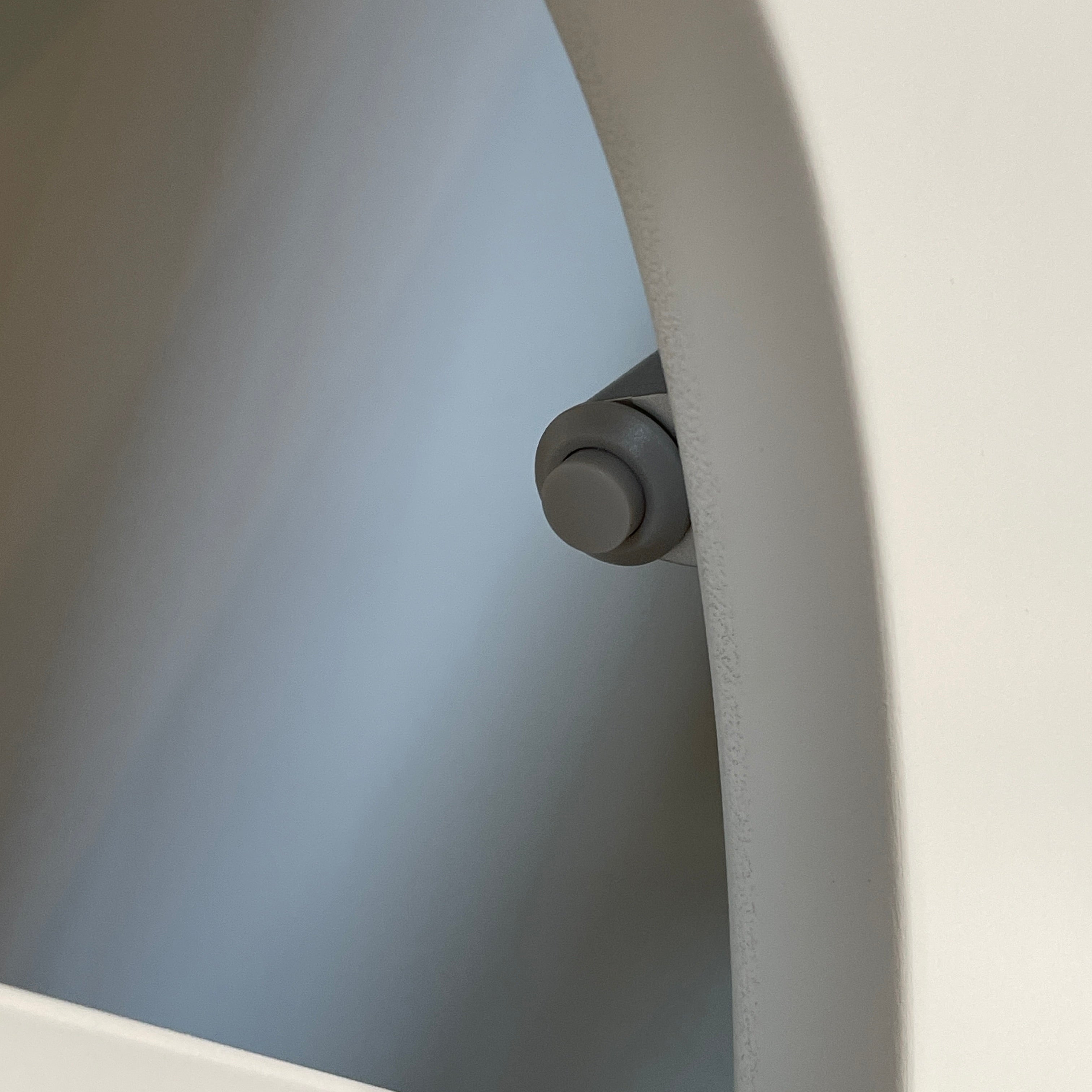 The Roche Bobois Denia Bookcase is a white bookshelf characterized by its abstract design, featuring multiple irregular oval cutouts, nine internal compartments, and integrated LED lighting, reminiscent of ROCHE BOBOIS styling.