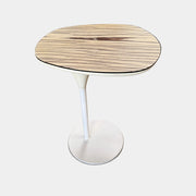 Moroso Bloomy Side Table with an oval, wood-grain top and a single, white pedestal base.