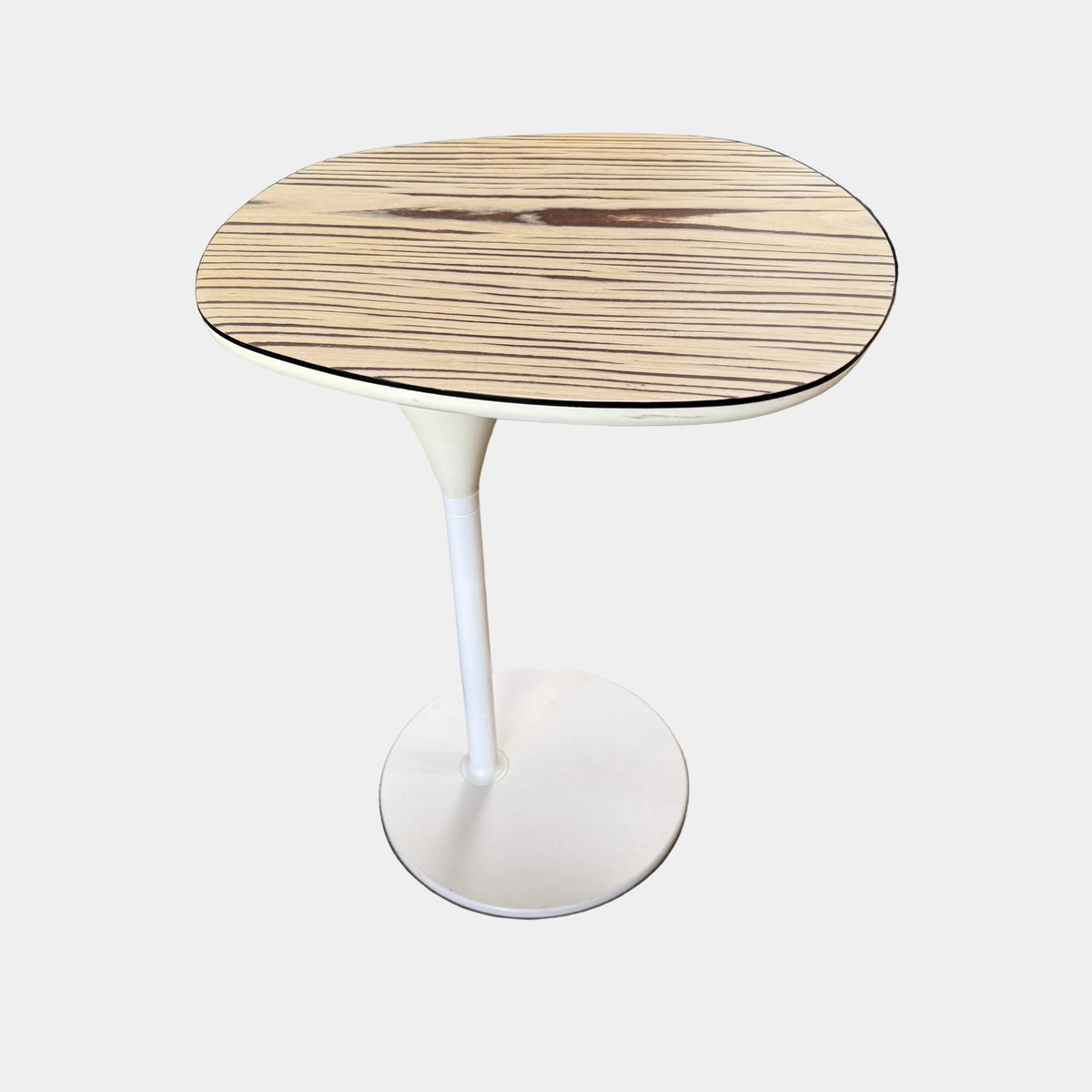 Moroso Bloomy Side Table with an oval, wood-grain top and a single, white pedestal base.
