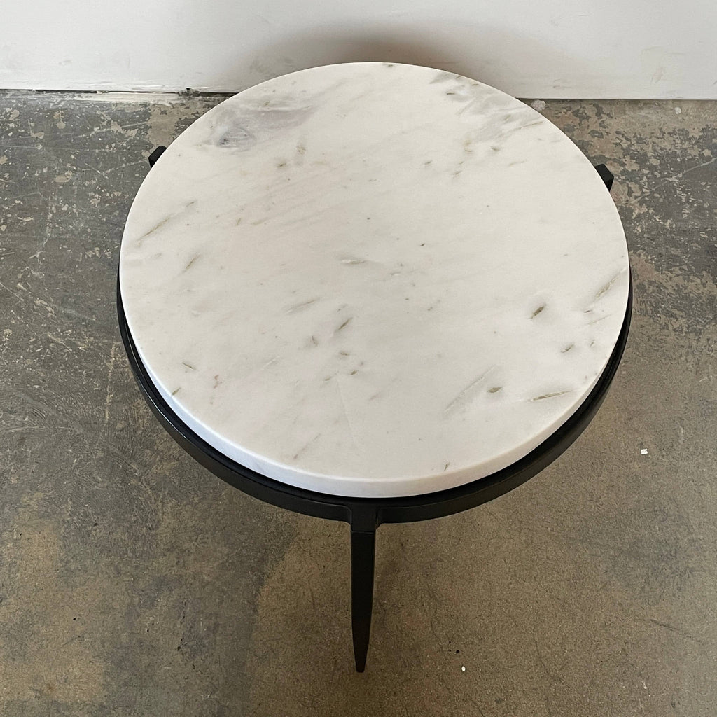 An Arteriors Kelsie Table with a marble top.
