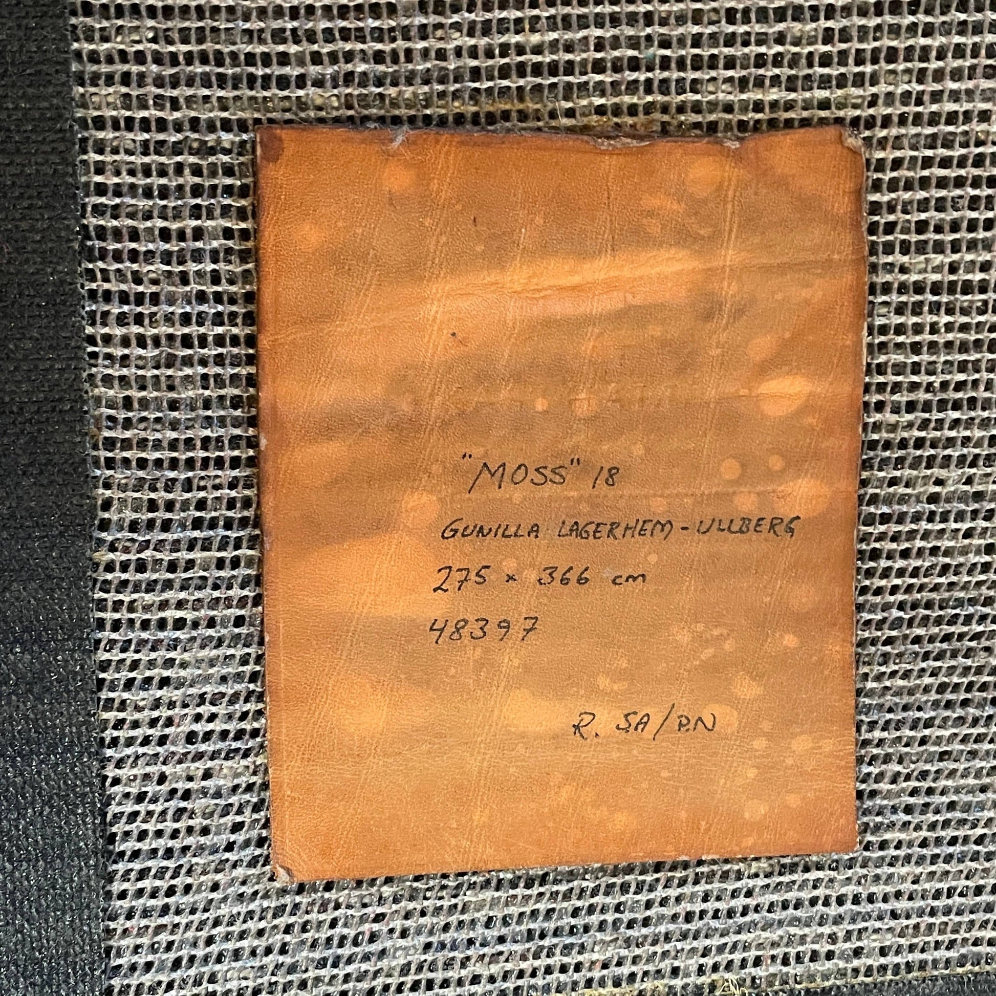 The Kasthall Moss Rug, designed by Gunnila Lagerhem Ullberg, is a hand-tufted rug featuring a shaggy black texture on a crisp white background.