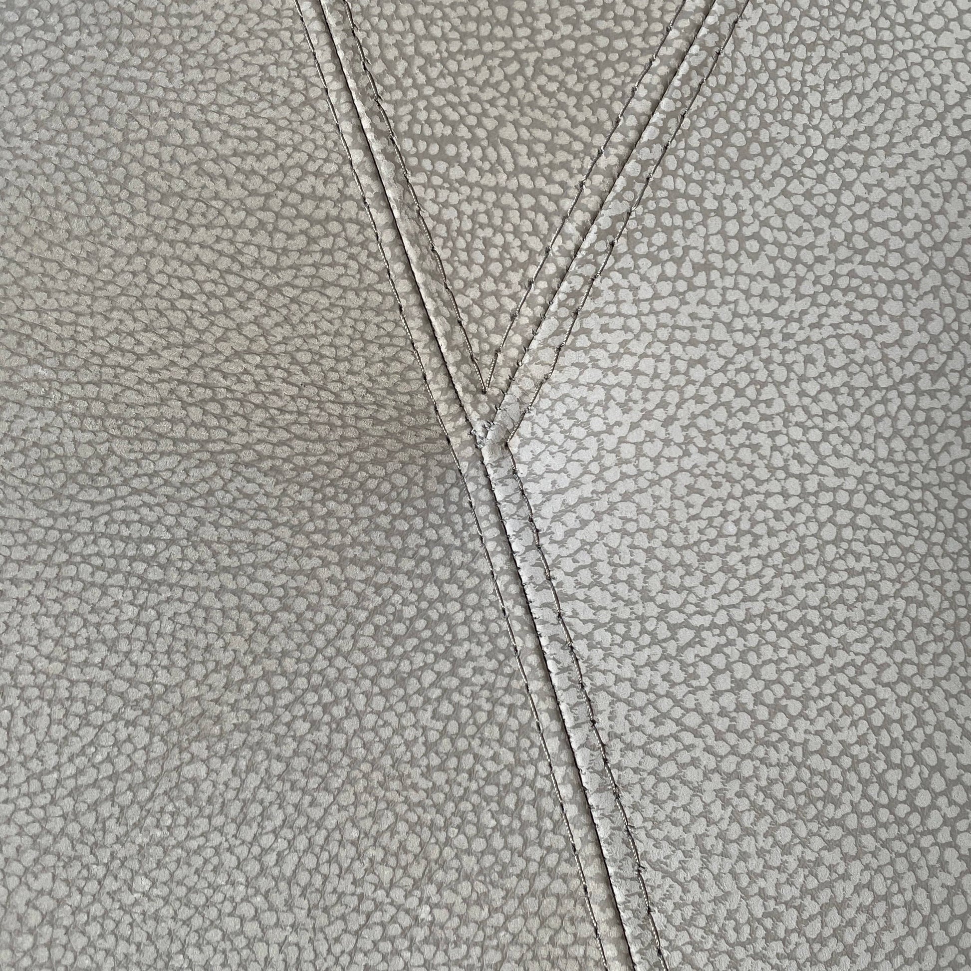 A Roche Bobois Digital Sofa and Ottoman, featuring a curved grey sectional design with three cushions and an additional round ottoman, set against a plain white background.