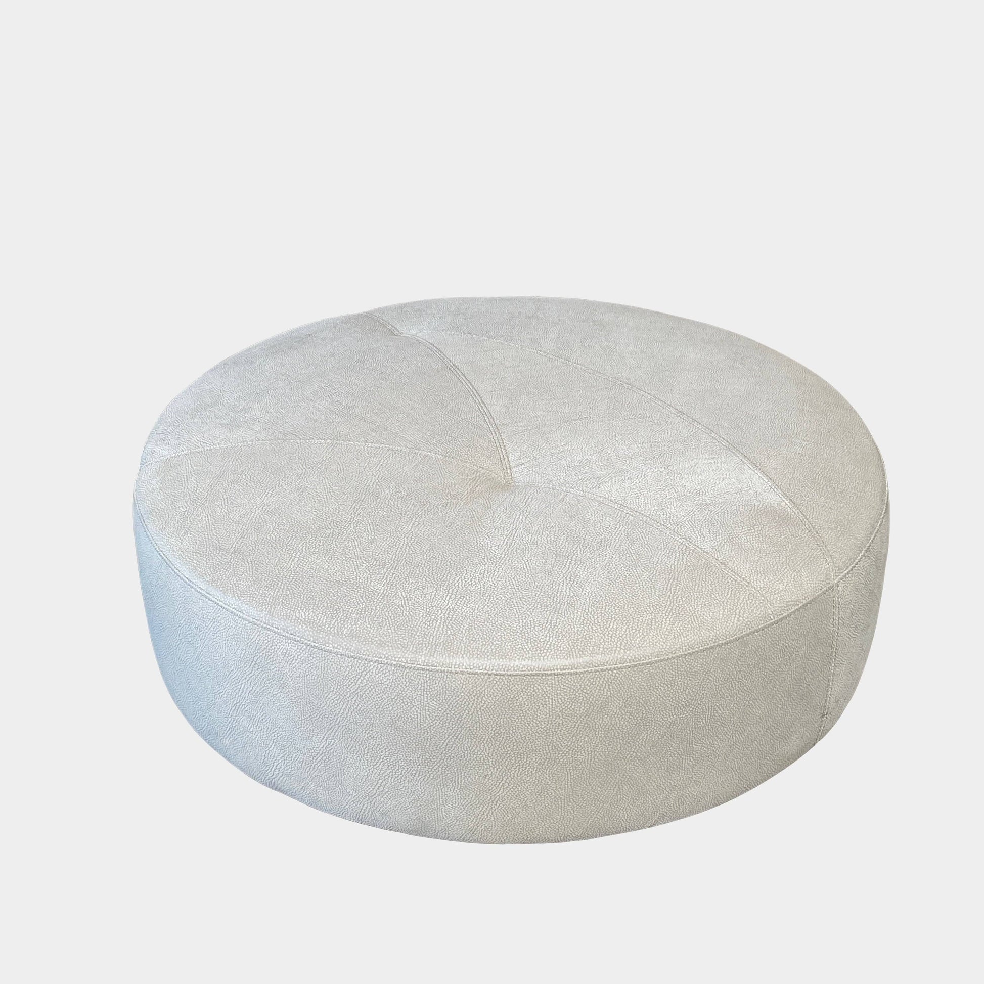 A Roche Bobois Digital Sofa and Ottoman, featuring a curved grey sectional design with three cushions and an additional round ottoman, set against a plain white background.