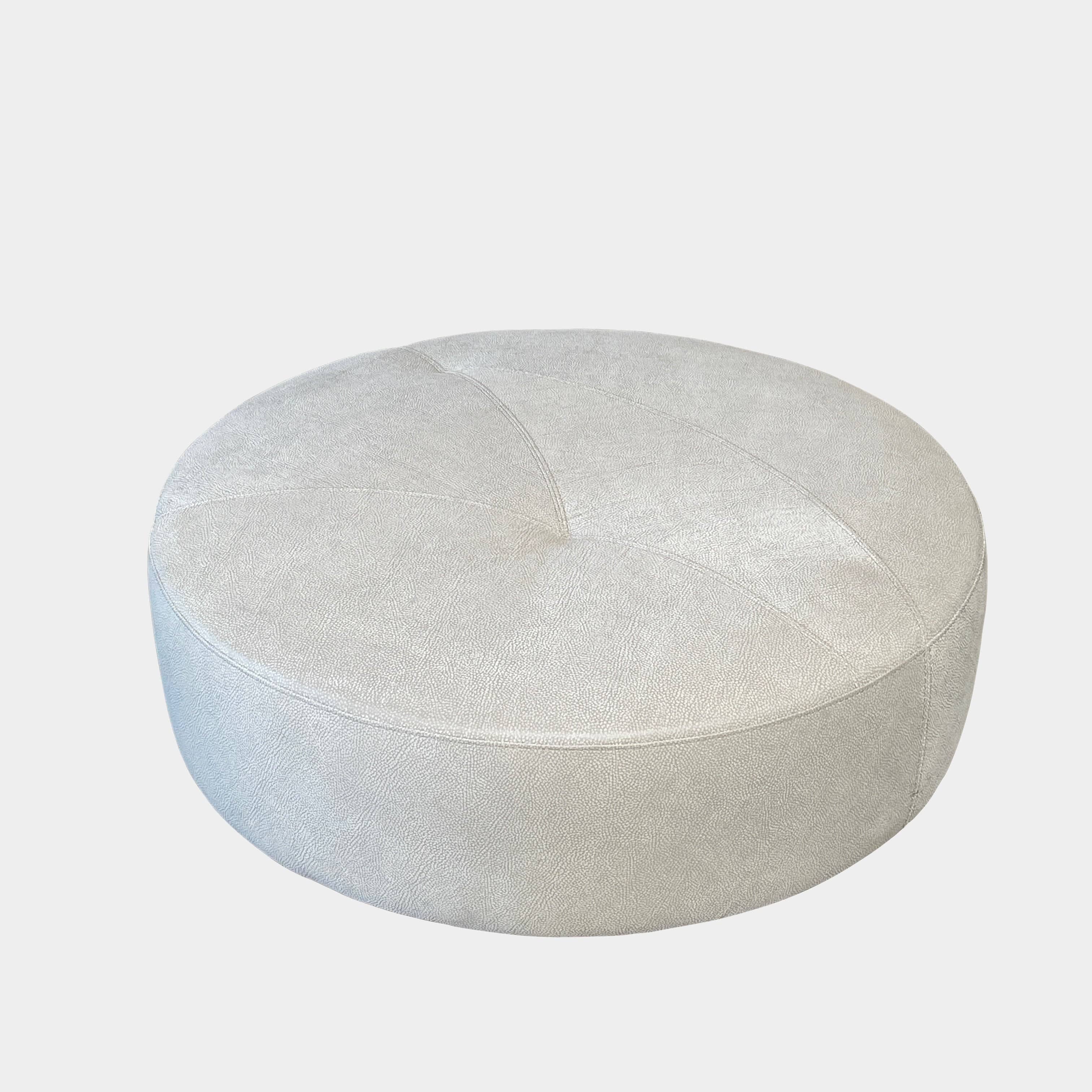 A Roche Bobois Digital Sofa and Ottoman, featuring a curved grey sectional design with three cushions and an additional round ottoman, set against a plain white background.