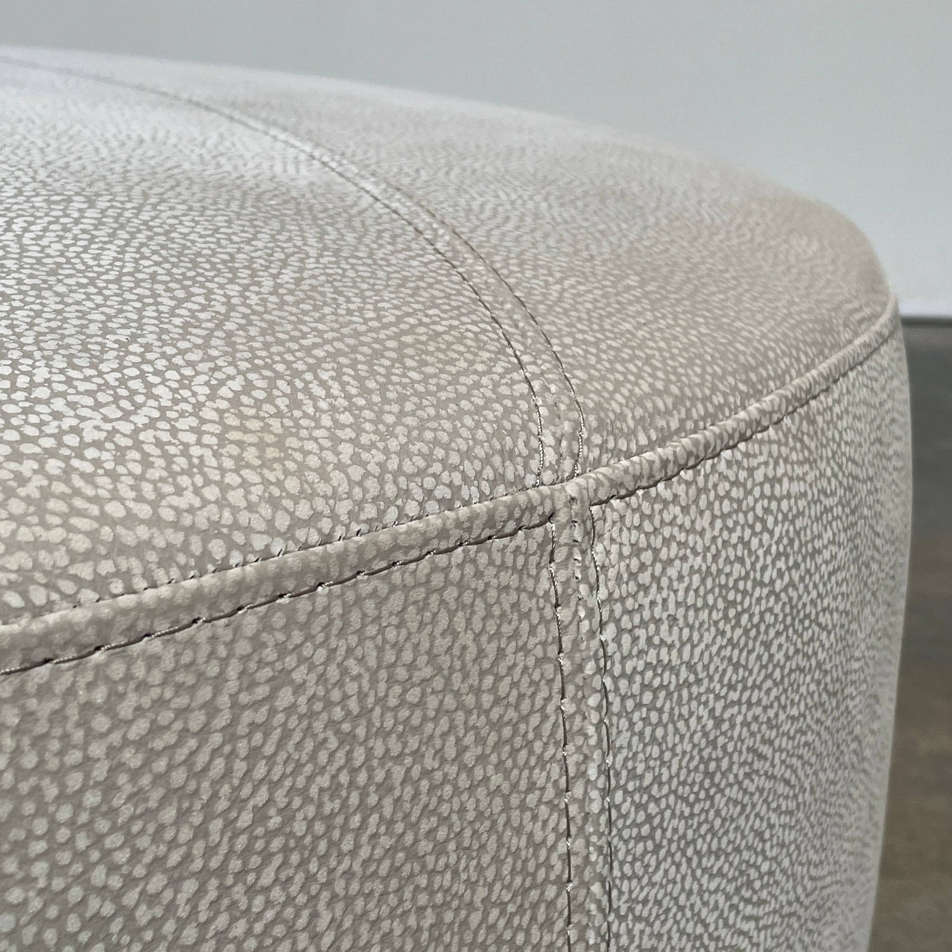 A Roche Bobois Digital Sofa and Ottoman, featuring a curved grey sectional design with three cushions and an additional round ottoman, set against a plain white background.