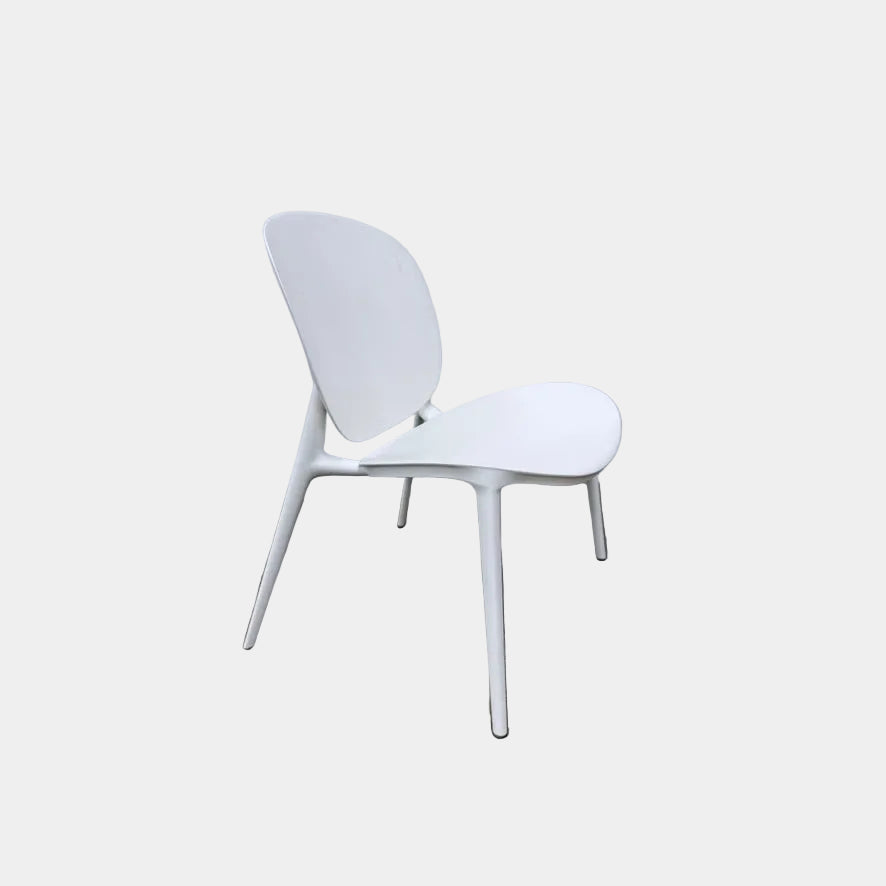 White Kartell Be Bop Lounge Chair with a rounded backrest and tapered legs, suitable for indoor and outdoor seating.