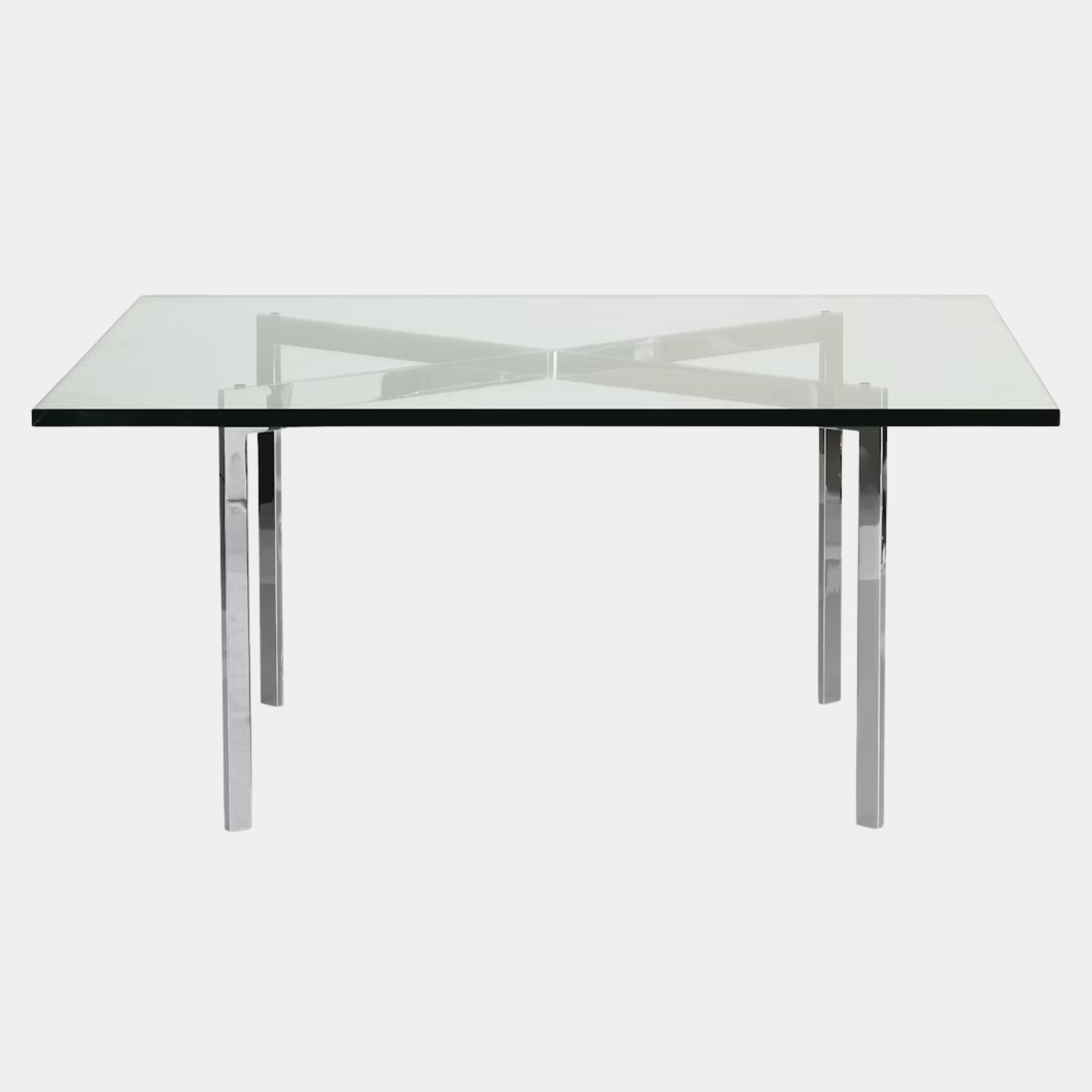 The Vintage DWR Barcelona Coffee Table by DWR features a rectangular glass top, four metal legs, and a visible metal support frame underneath.