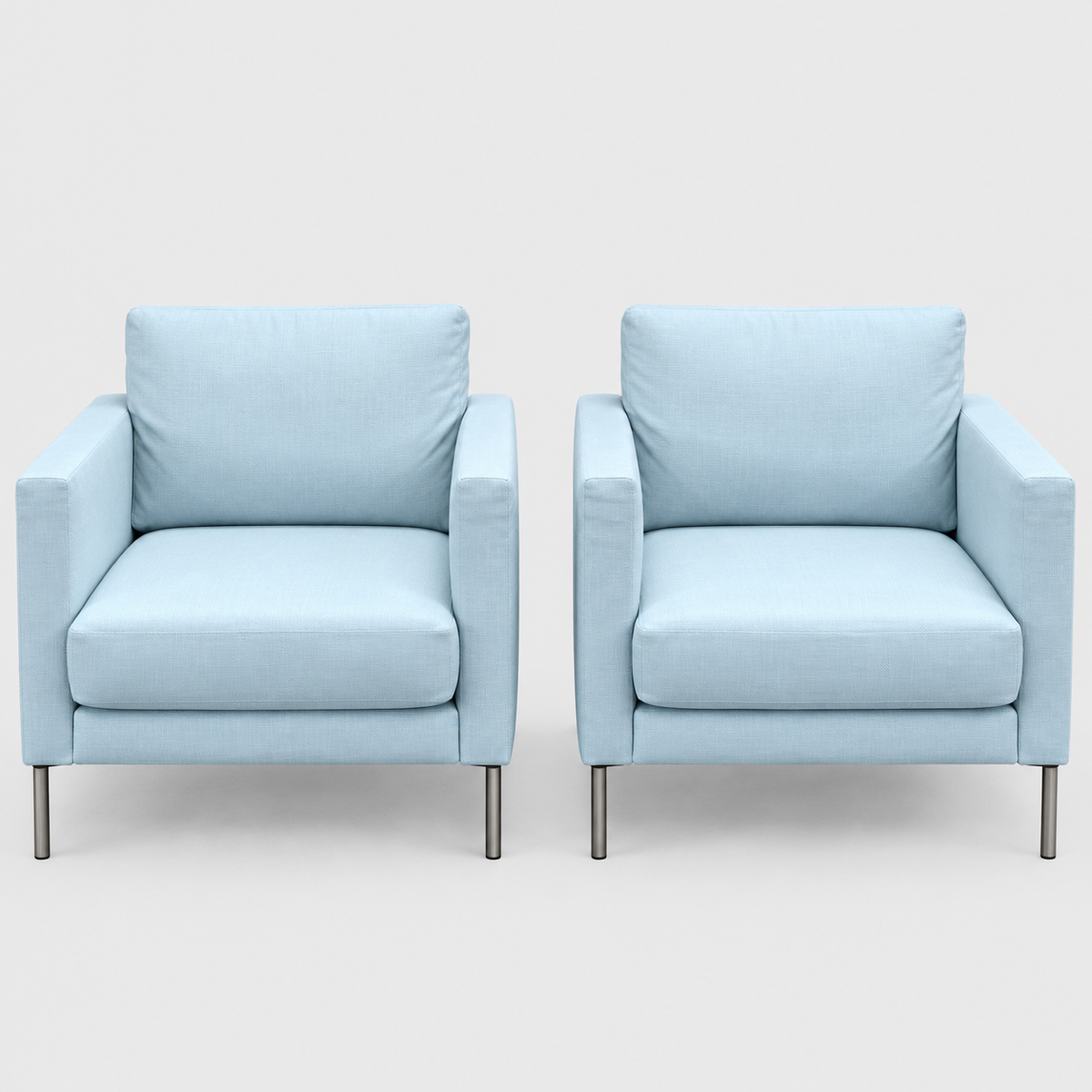 Two light blue Knoll Divina Petite Lounge Chairs with thin metal legs.
