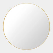The Gubi 43″ Round Wall Mirror in Polished Brass, by Gubi, is displayed against a plain light gray background, showcasing its sleek and timeless design inspired by the iconic Gubi wall mirror.