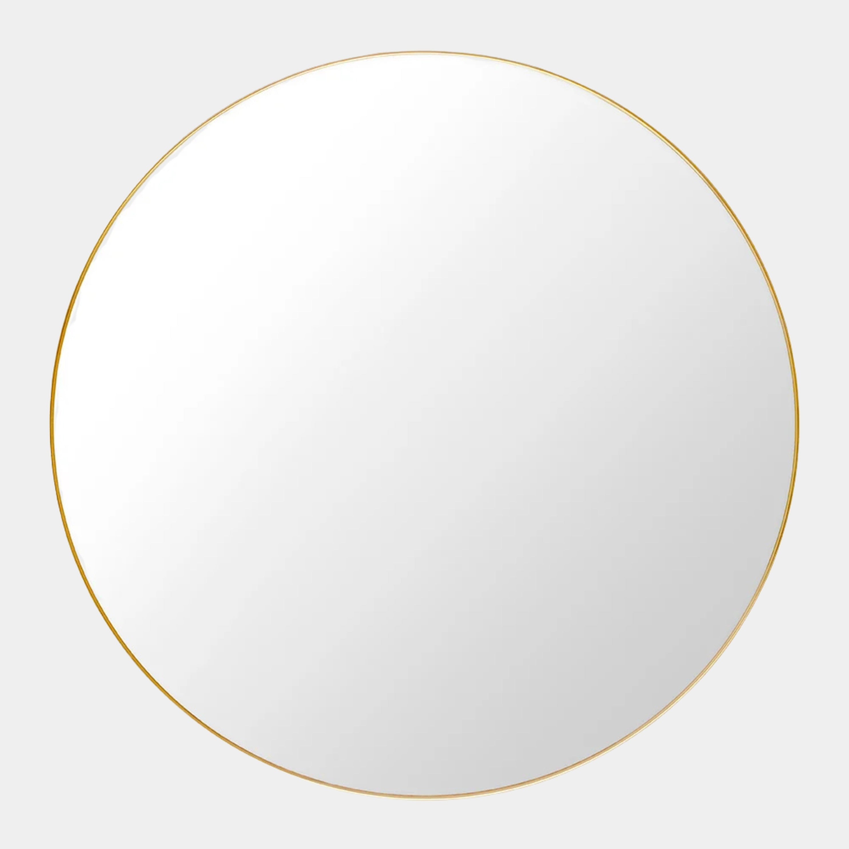 The Gubi 43″ Round Wall Mirror in Polished Brass, by Gubi, is displayed against a plain light gray background, showcasing its sleek and timeless design inspired by the iconic Gubi wall mirror.