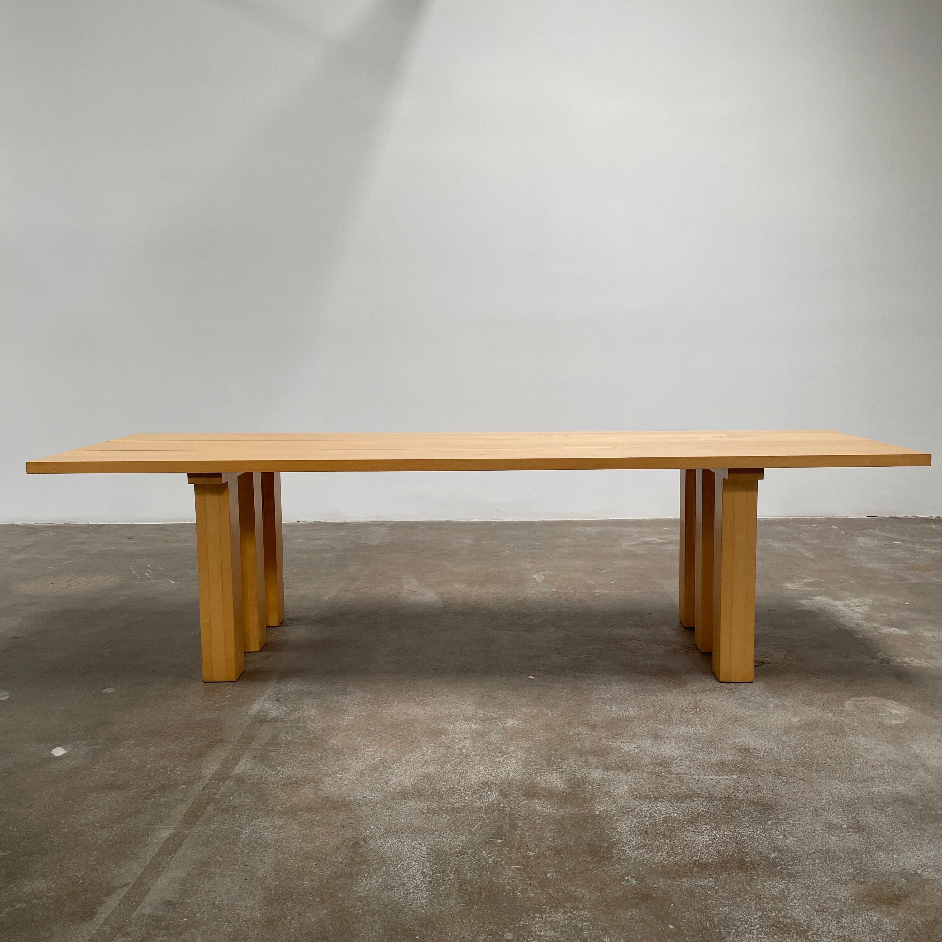 A Vintage Cassina La Basilica Dining Table by Mario Bellini, featuring a wooden rectangular design with a simple aesthetic and four legs, evocative of the iconic architectural style.