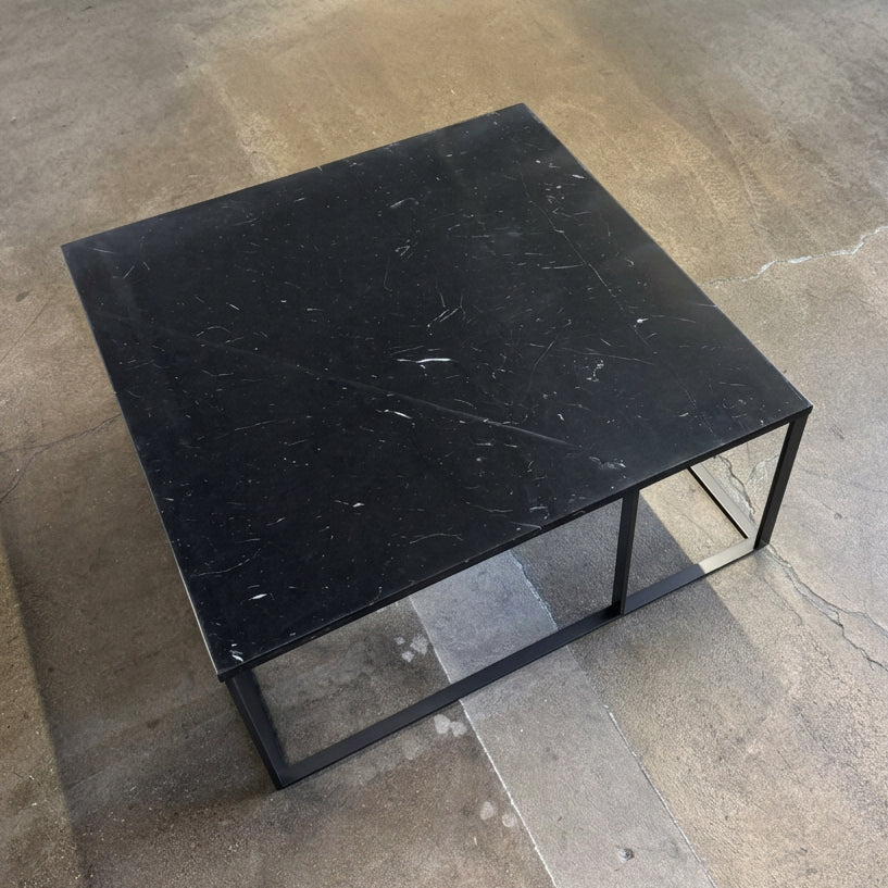 Square Maxalto Lithos coffee table with a black marble top and a black metal frame.