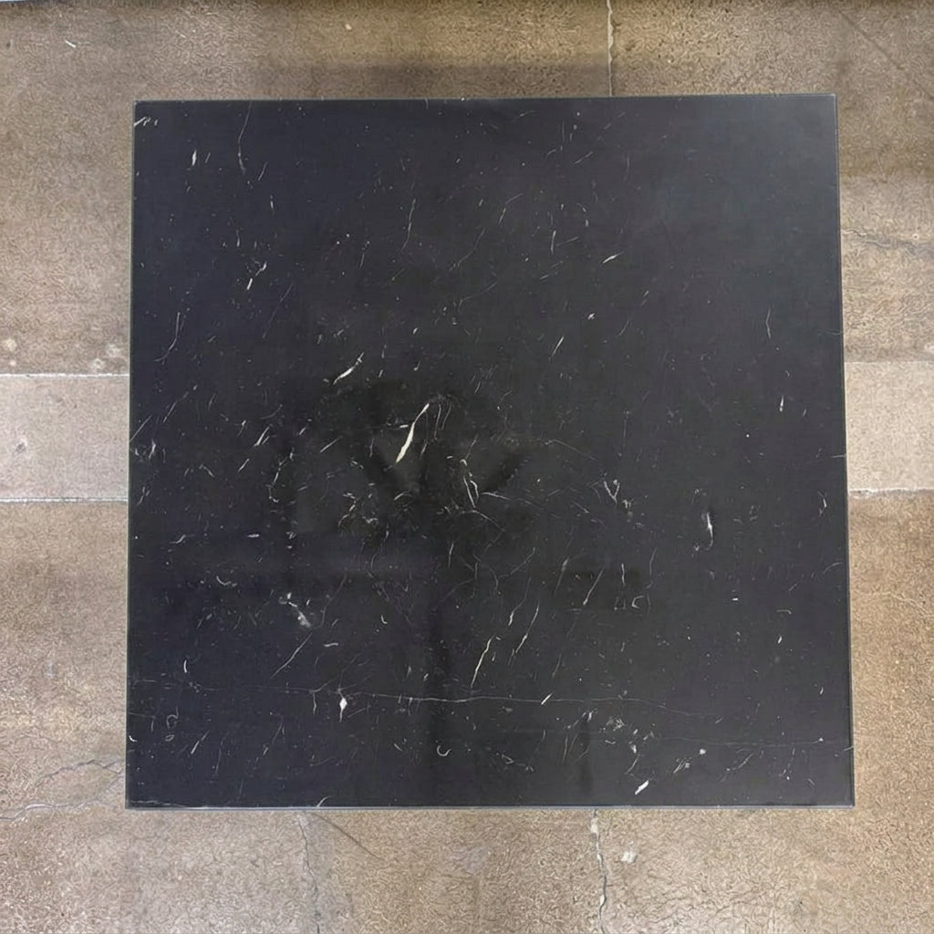 Square Maxalto Lithos coffee table with a black marble top and a black metal frame.