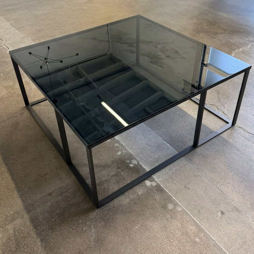 Square Maxalto Lithos coffee table with a black marble top and a black metal frame.
