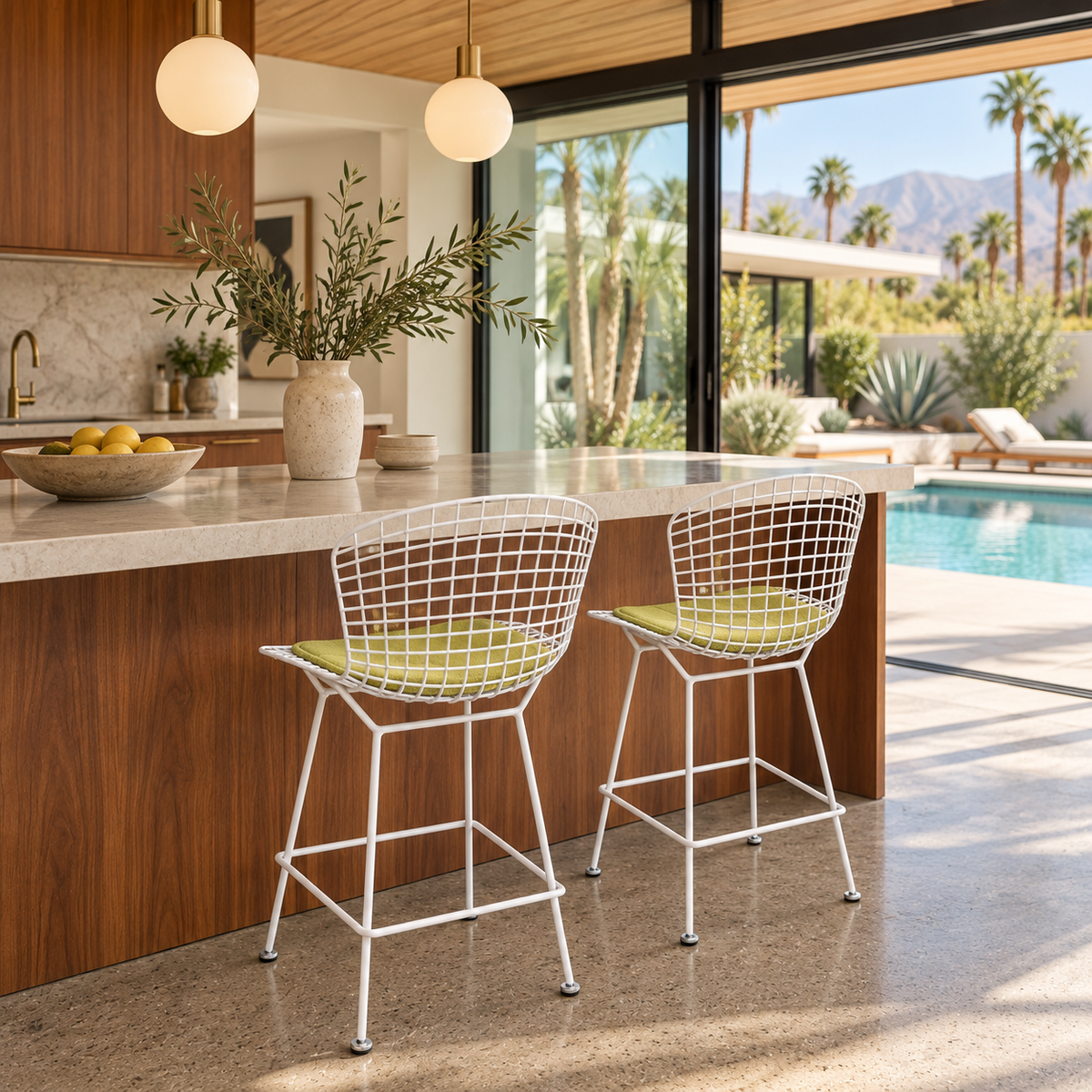 Two white Knoll Harry Bertoia Wire Counter Stools with light green seat cushions.