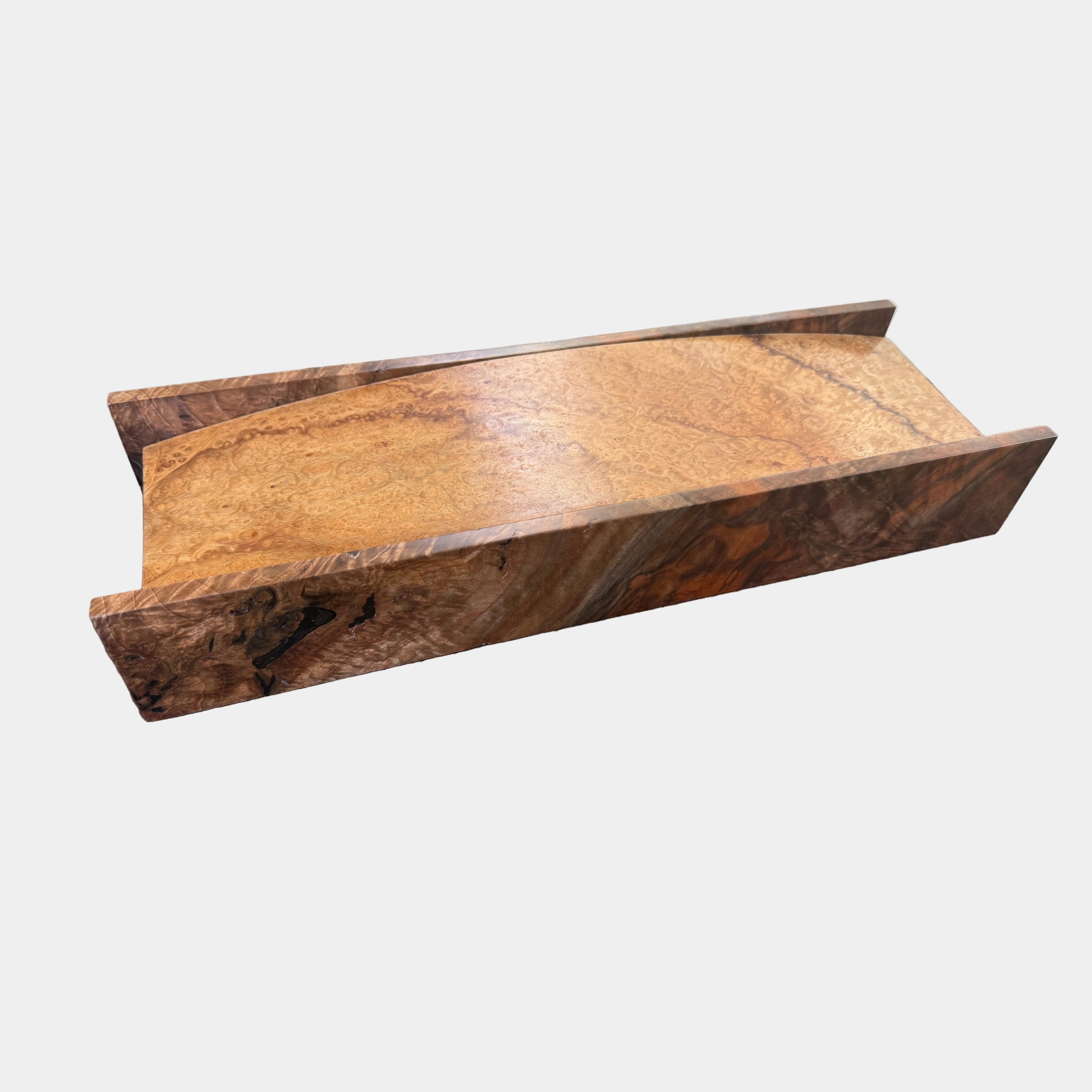 The MIke Fair Table Top Storage Box by Mike Fair Custom Furnishings features a rectangular design with raised sides and a glossy finish, highlighting the natural camphor burl and claro walnut wood grain. It is displayed on a white surface.