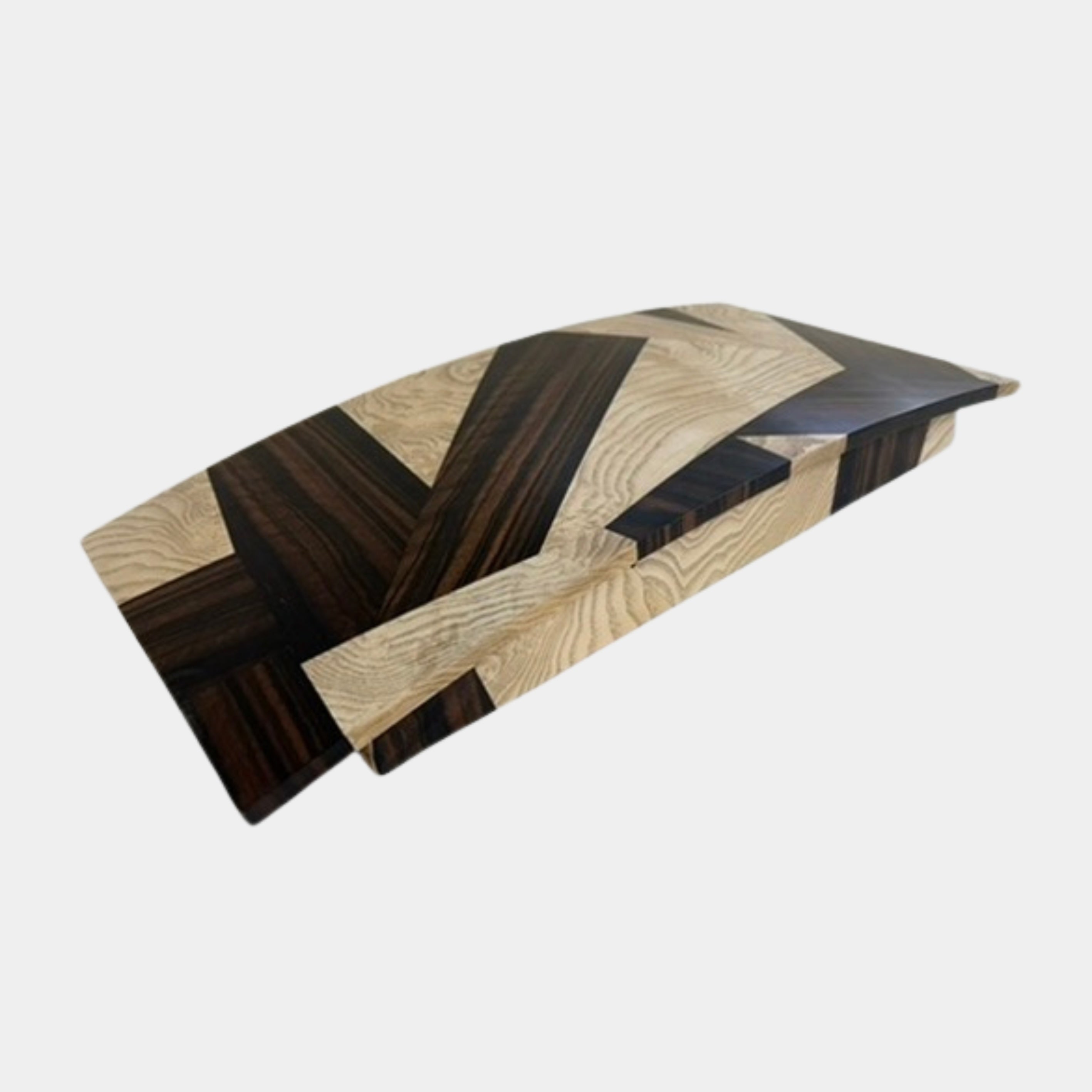 A rectangular table top storage box by Mike Fair Custom Furnishings, crafted from luxurious Macassar Ebony and Ash Burl with a geometric patterned lid, is displayed open to reveal a foam insert inside. The elegant Mike Fair Table Top Storage Box rests on a light fabric surface.