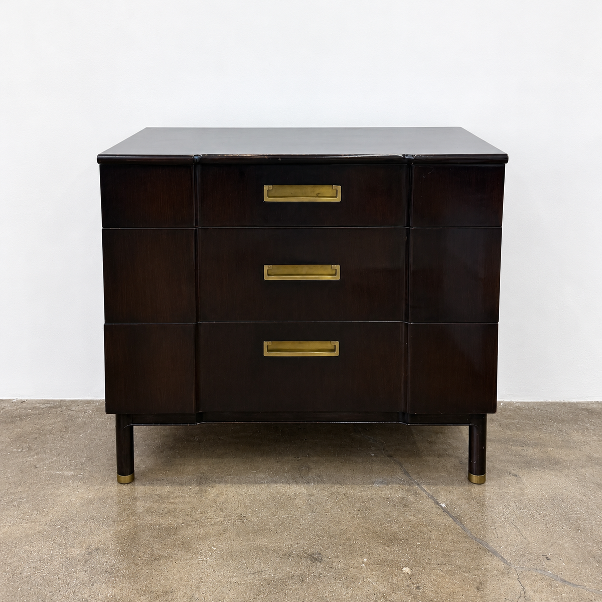 Vintage John Widdicomb Three Drawer Chest in dark wood, featuring three drawers with rectangular brass pulls and tapered legs.