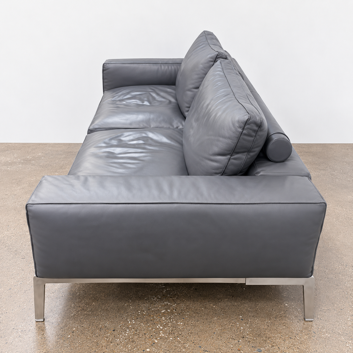 Flexform Lifesteel gray leather sofa on a thin metal frame with slender legs.