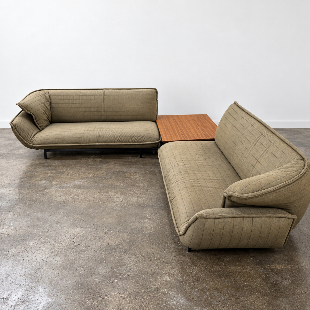 Two tan upholstered Cassina Beam Sectional Sofa with Corner Table sections connected by a rectangular wooden corner table.