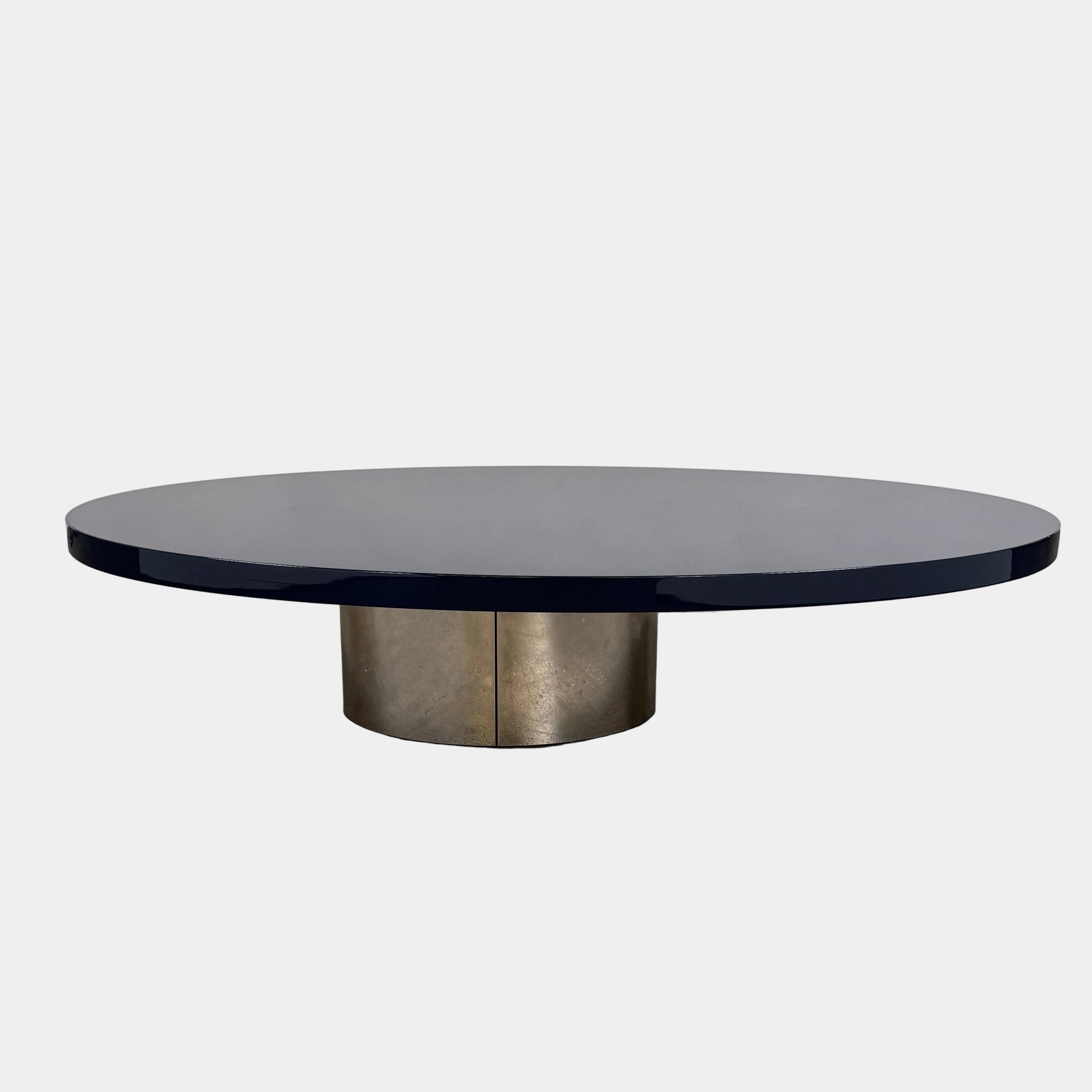 A sleek Minotti Raymond Coffee Table with a metal base, exhibiting clean shapes and proportions.