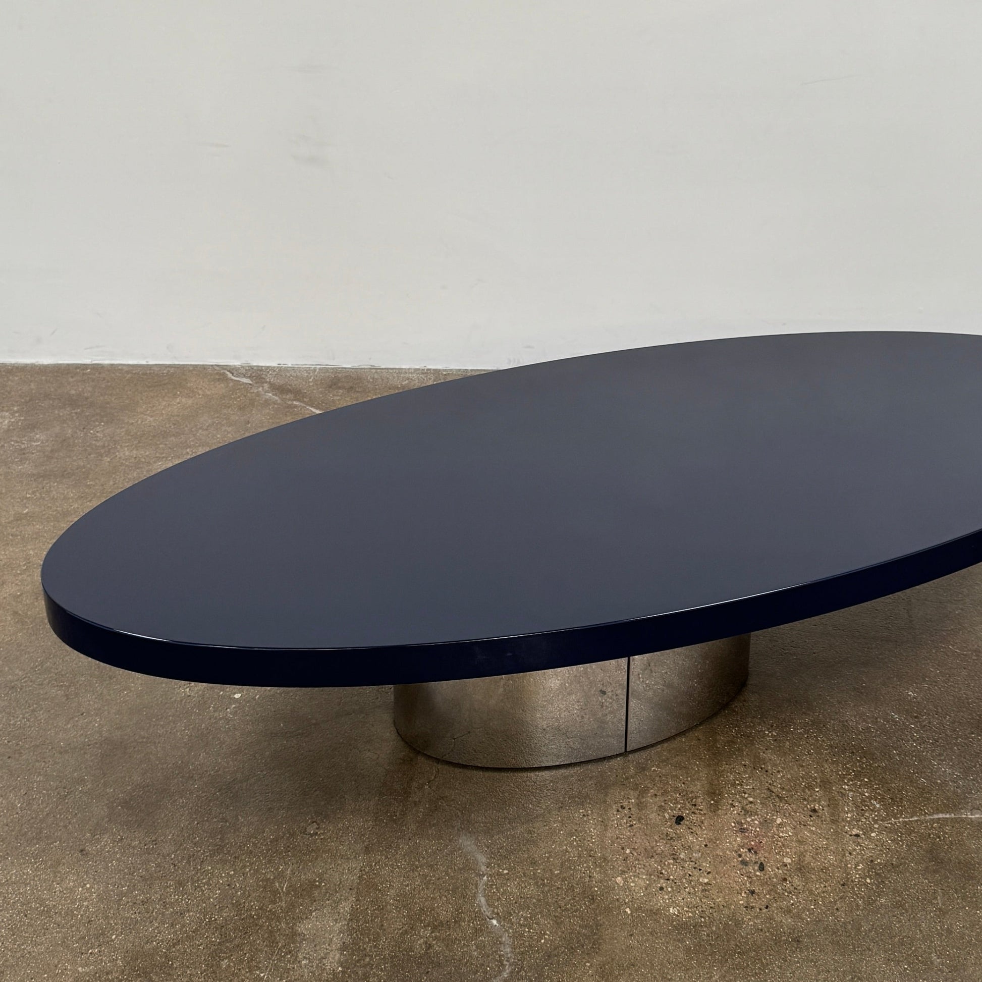 A sleek Minotti Raymond Coffee Table with a metal base, exhibiting clean shapes and proportions.