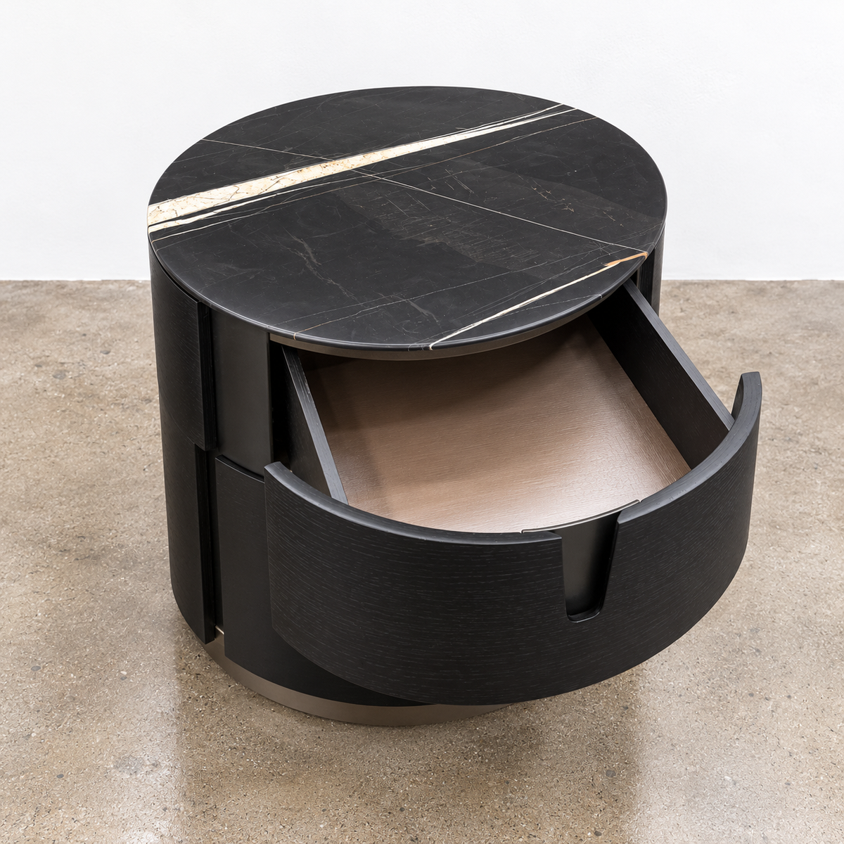 Two cylindrical Porada Tylsa 54 Nightstand Set of 2 units with dark marble tops featuring a single light-colored vein.