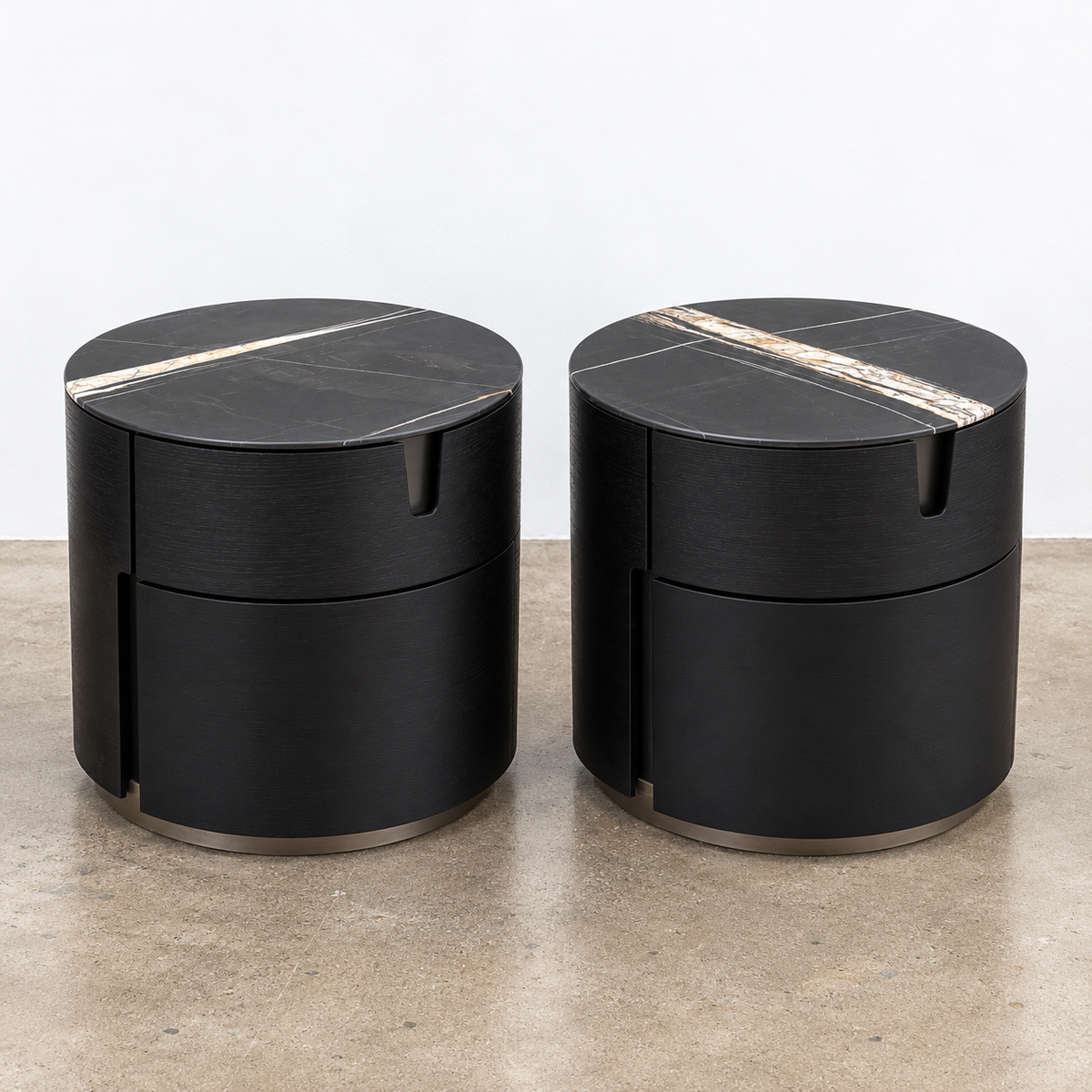 Two cylindrical Porada Tylsa 54 Nightstand Set of 2 units with dark marble tops featuring a single light-colored vein.