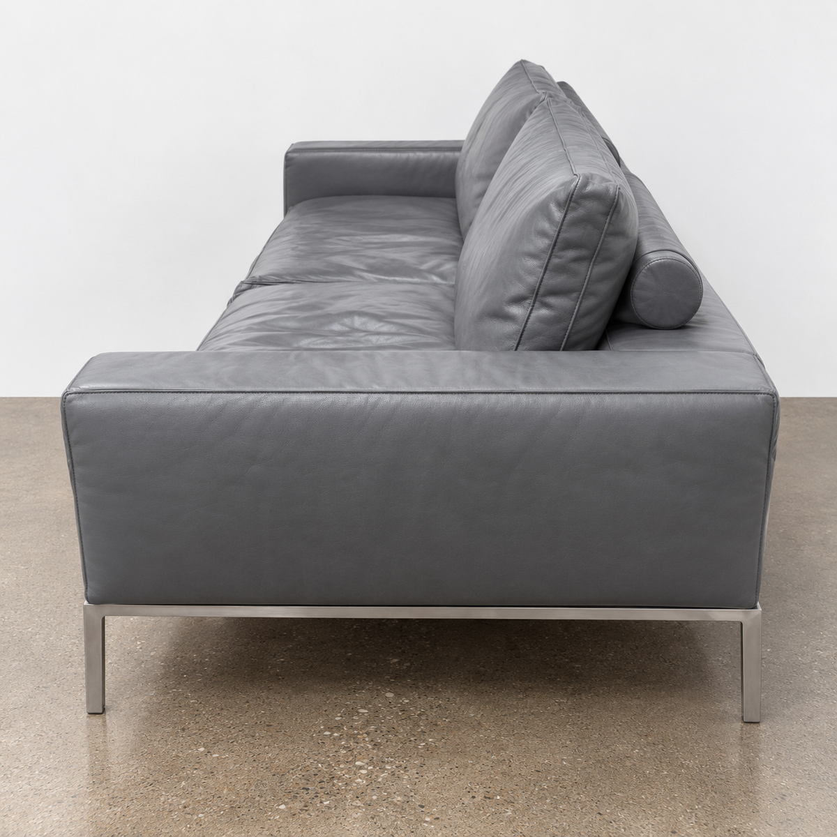 Flexform Lifesteel gray leather sofa on a thin metal frame with slender legs.