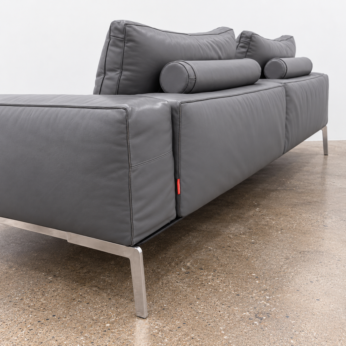 Flexform Lifesteel gray leather sofa on a thin metal frame with slender legs.