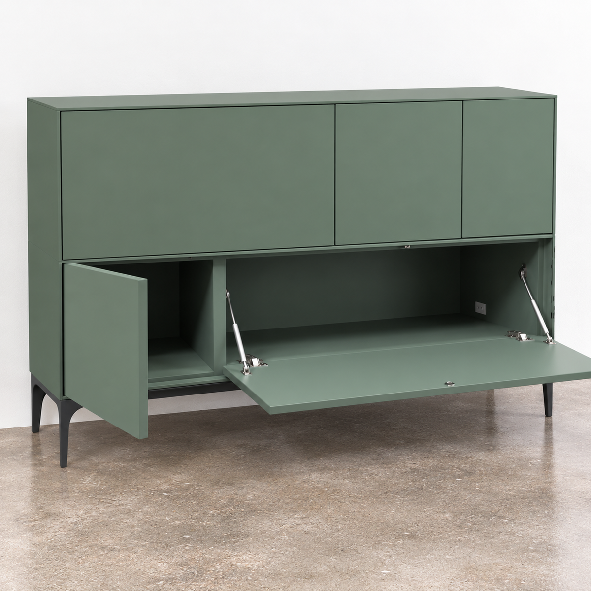 A sage green Treku Lauki cabinet featuring five asymmetrical doors and black metal legs in a contemporary design.