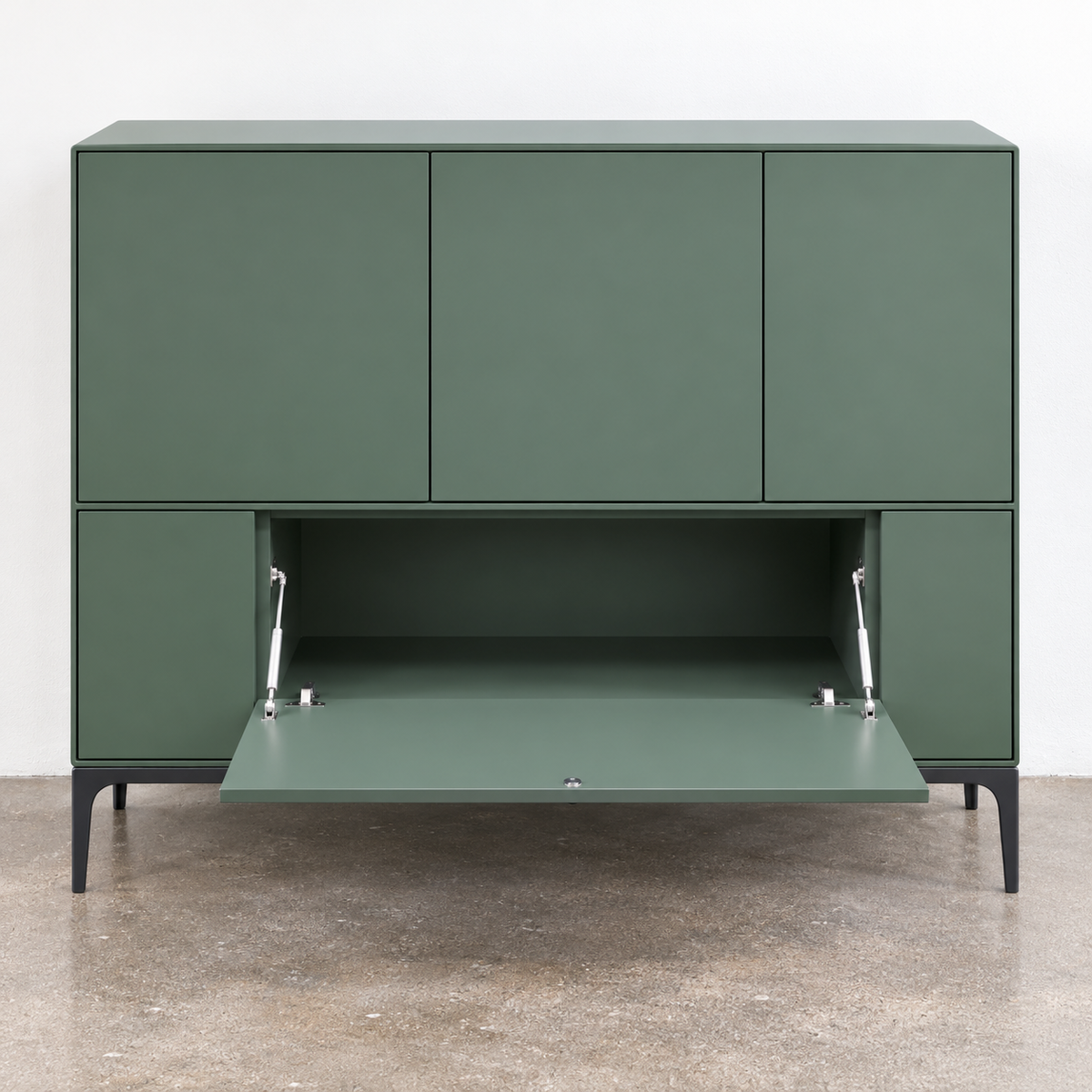 A sage green Treku Lauki cabinet featuring five asymmetrical doors and black metal legs in a contemporary design.
