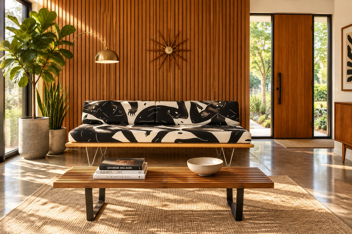 The Limited Edition Modernica + Cleon Peterson Case Study Daybed 2016 features metal hairpin legs and black-and-white cushions with abstract human figure illustrations by Cleon Peterson.