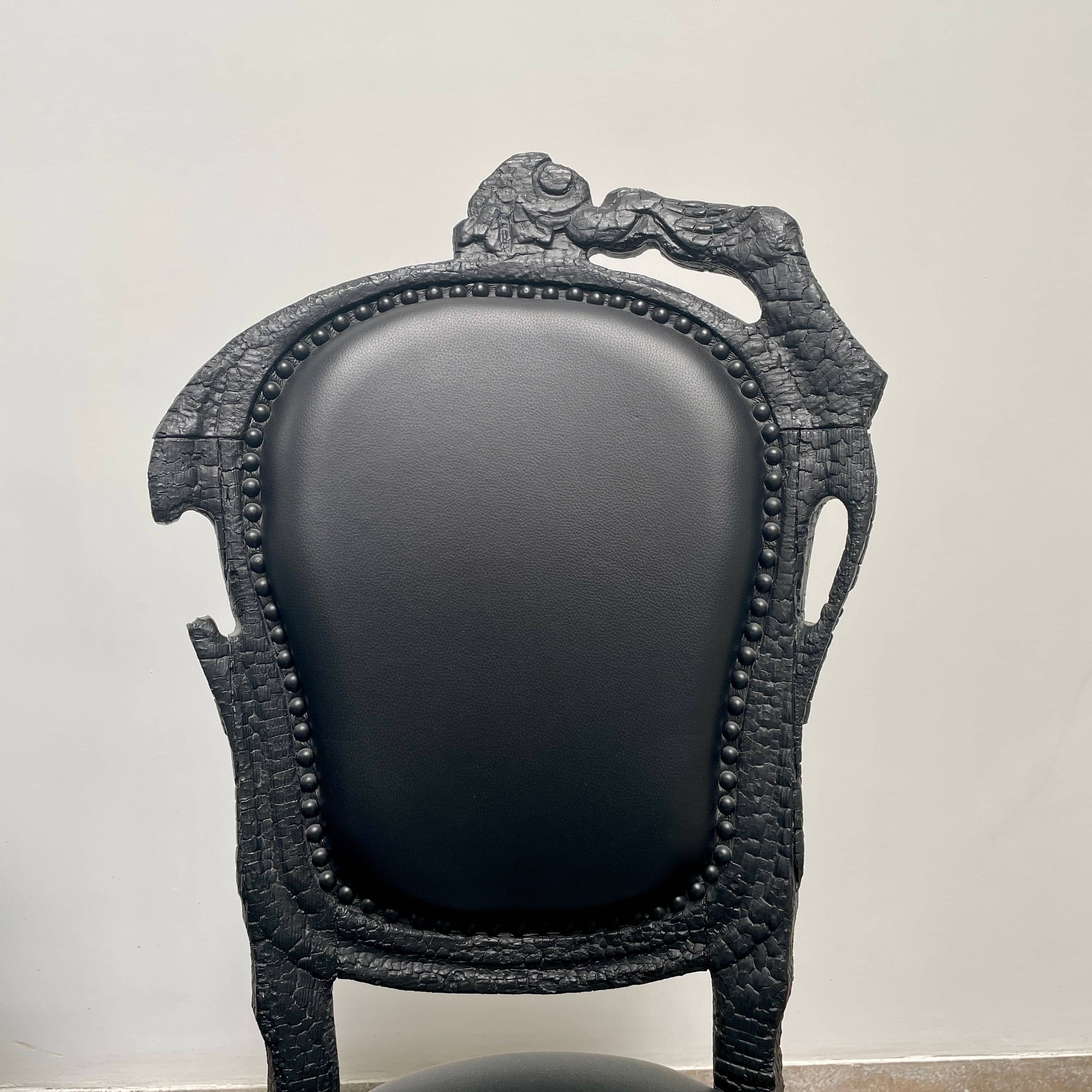 A set of seven Moooi Smoke Dining Side Chairs, crafted by Moooi in an ornate black finish with leather upholstery and cushioned seats and backs, arranged in two rows against a plain white background.