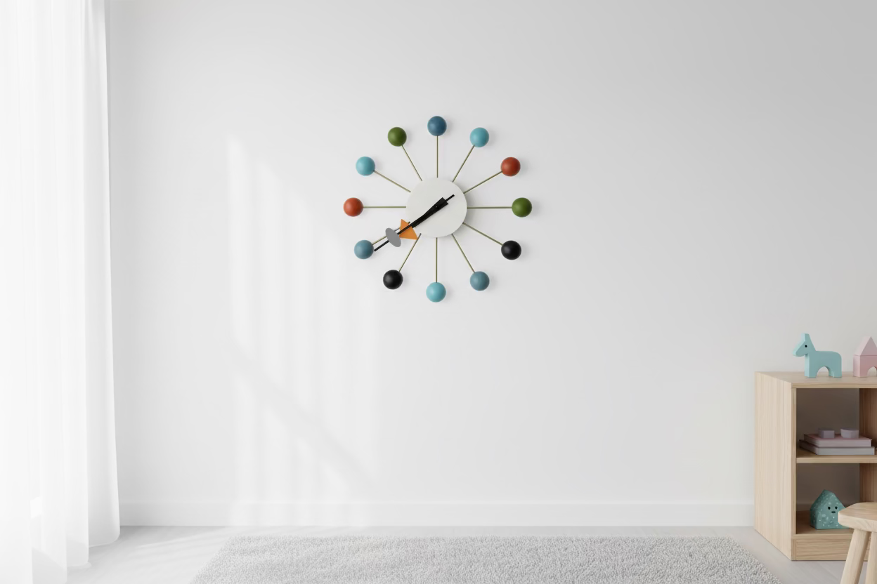 The Vitra Nelson Ball Clock - Multicolor by Vitra features a white circular face, multicolored ball hour markers, and sleek black hands, inspired by the classic mid-century modern Nelson Ball Clock design.