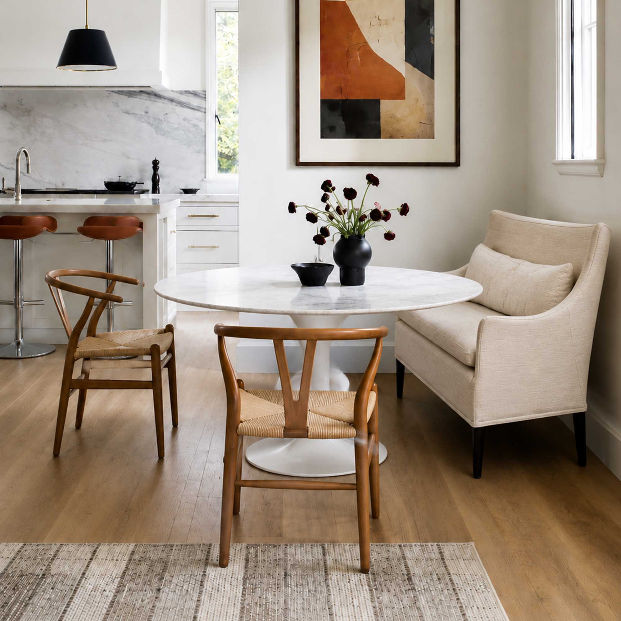 A Vintage Giorgetti Settee by Giorgetti, upholstered in beige with two matching cushions, black legs, and a high back, is placed on a polished concrete floor against a plain white wall.