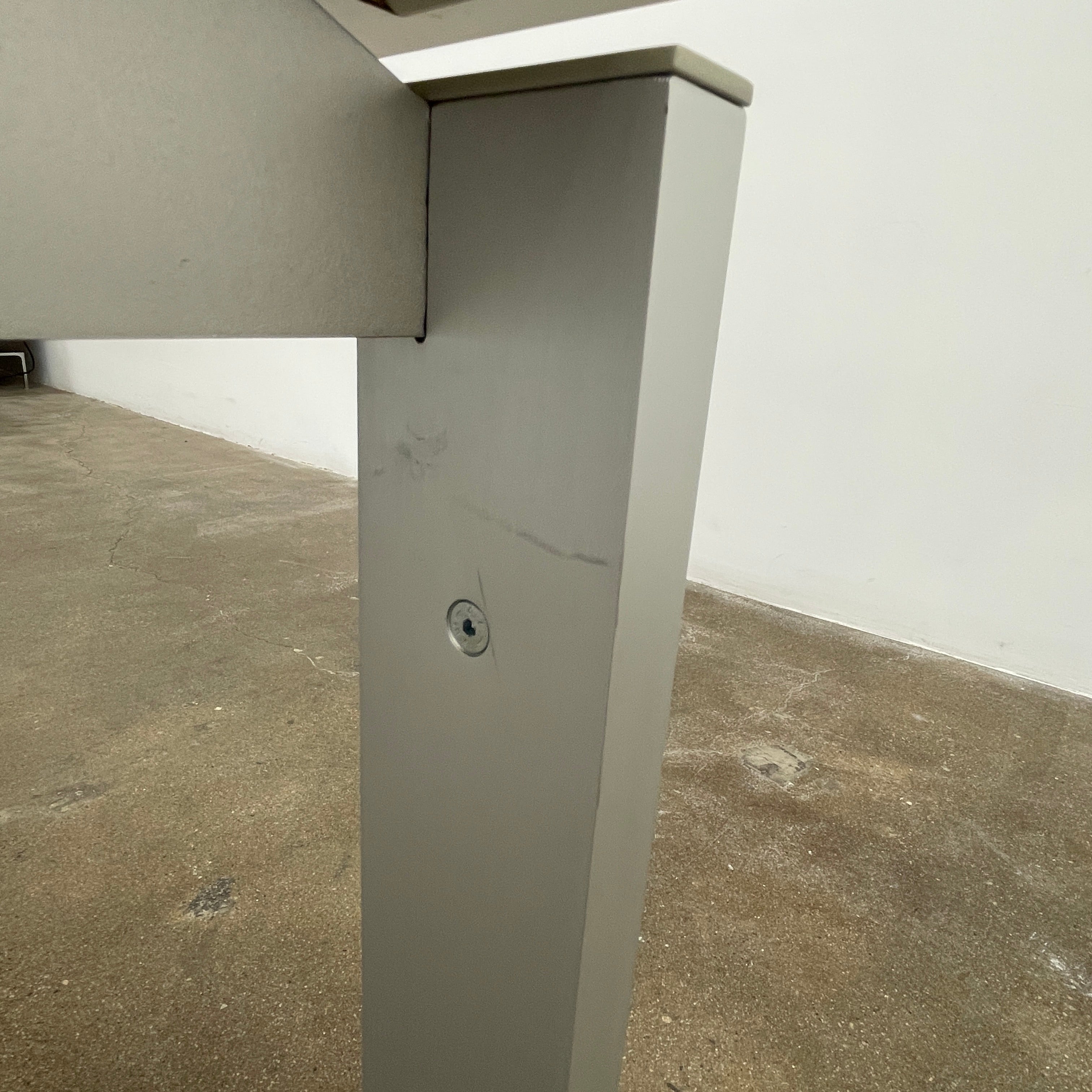 The Pallucco Italia Little Wing Dining Table features a sleek rectangular white top and four straight metal legs—an elegant aluminum dining table by Pallucco Italia, perfect for modern interiors.