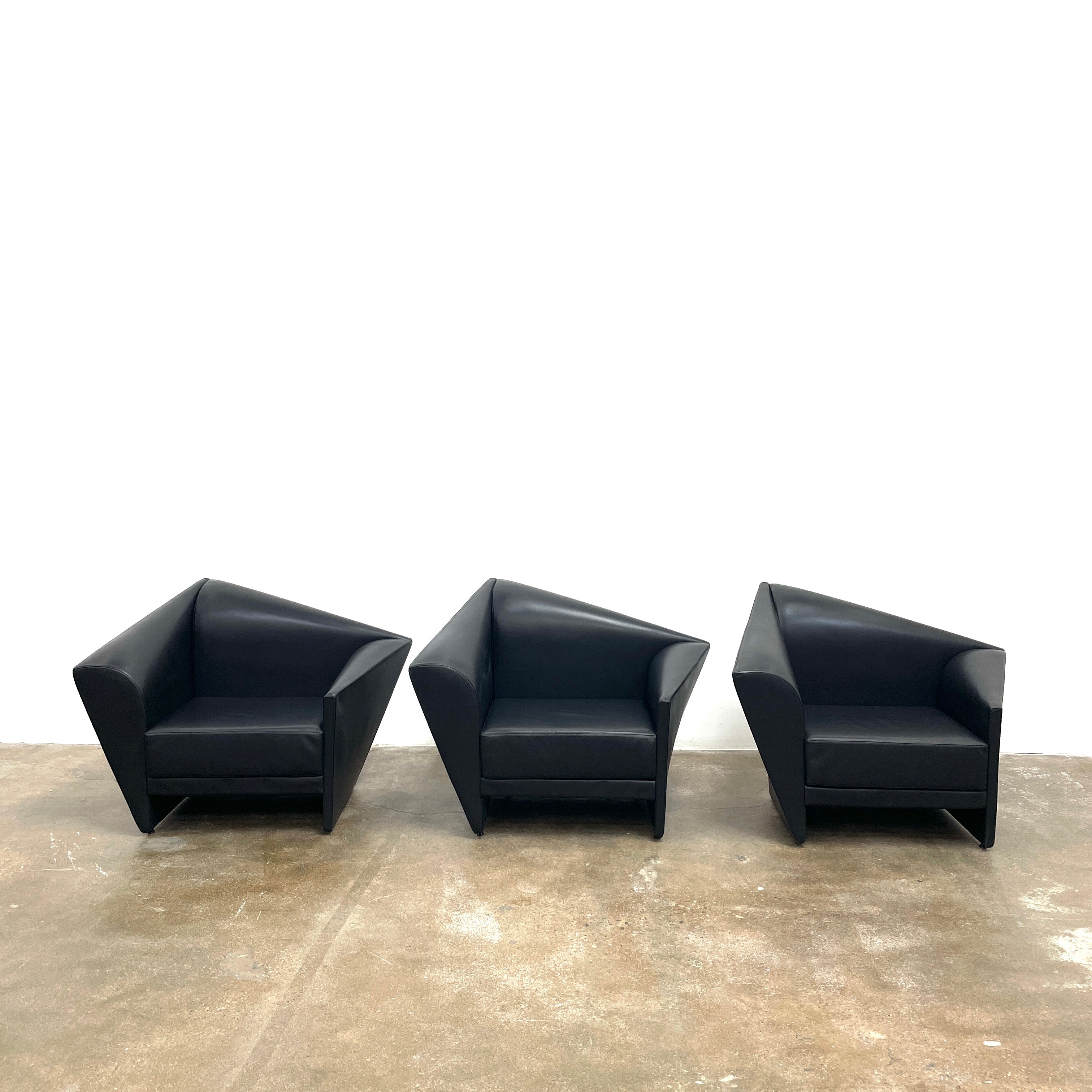 The Lilly of the Wind Armchair by Paolo Pallucco and Mireille Rivier for Pallucco Italia showcases a black leather finish and angular, modern design on a light gray background, echoing Paolo Pallucco's post-modern style.