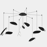 The Sonneman Lighting Papillons Swag LED pendant by Sonneman features elegant black and white oval shapes suspended from thin wires, radiating from a central black hub for a modern ceiling lighting statement.