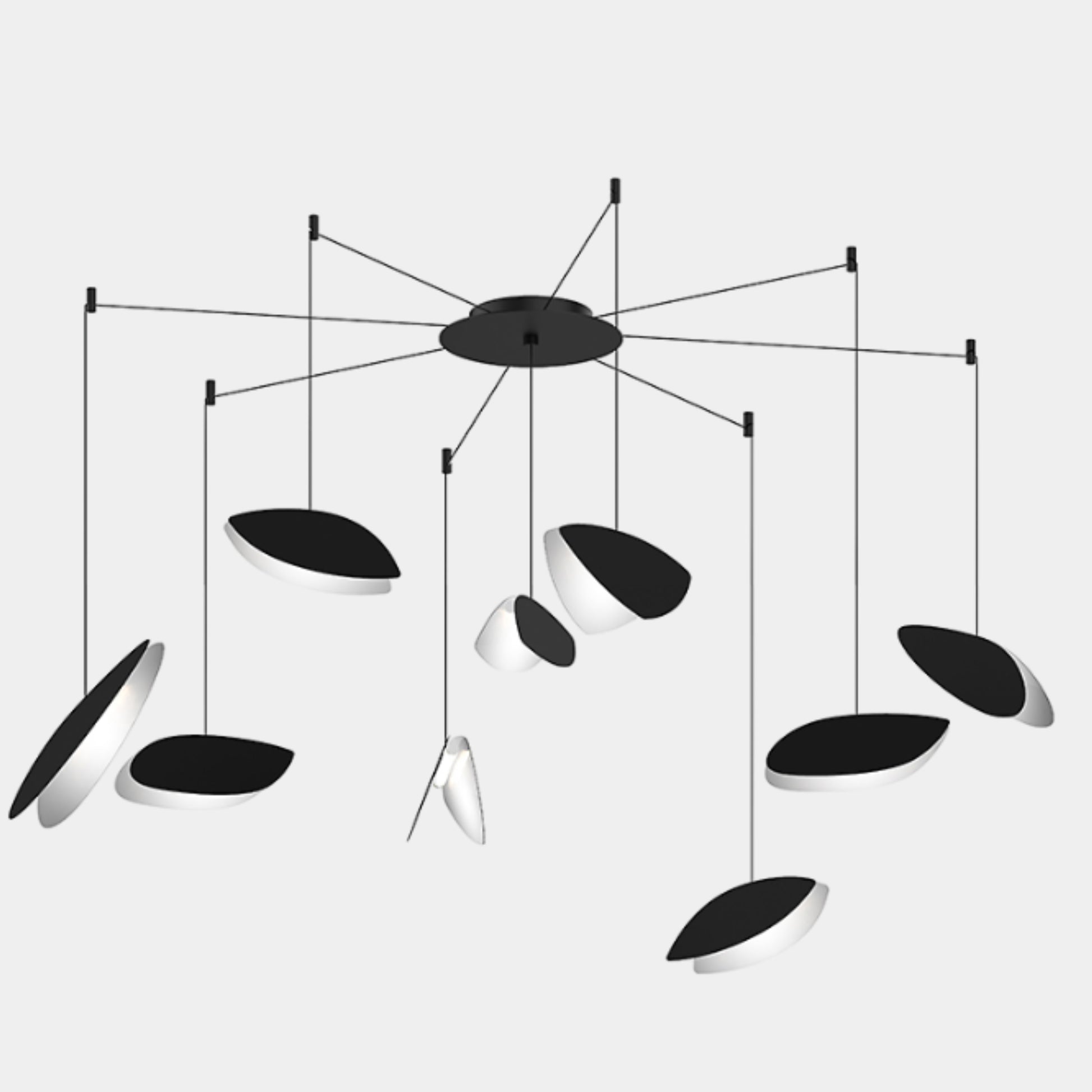 The Sonneman Lighting Papillons Swag LED pendant by Sonneman features elegant black and white oval shapes suspended from thin wires, radiating from a central black hub for a modern ceiling lighting statement.